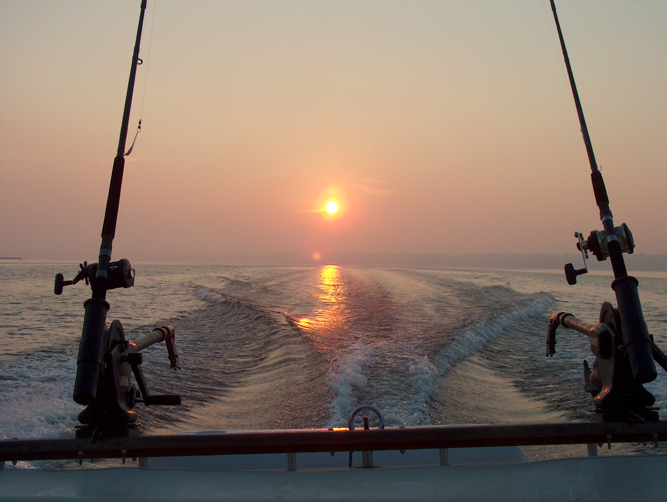 SAME SUN COMING UP BETWEEN DOWNRIGGERS & POLES ON WHITE LAKE