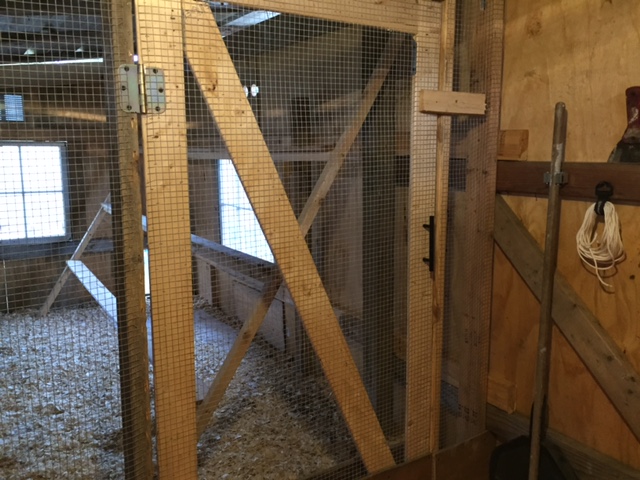 Self made door with latch leading into coop.