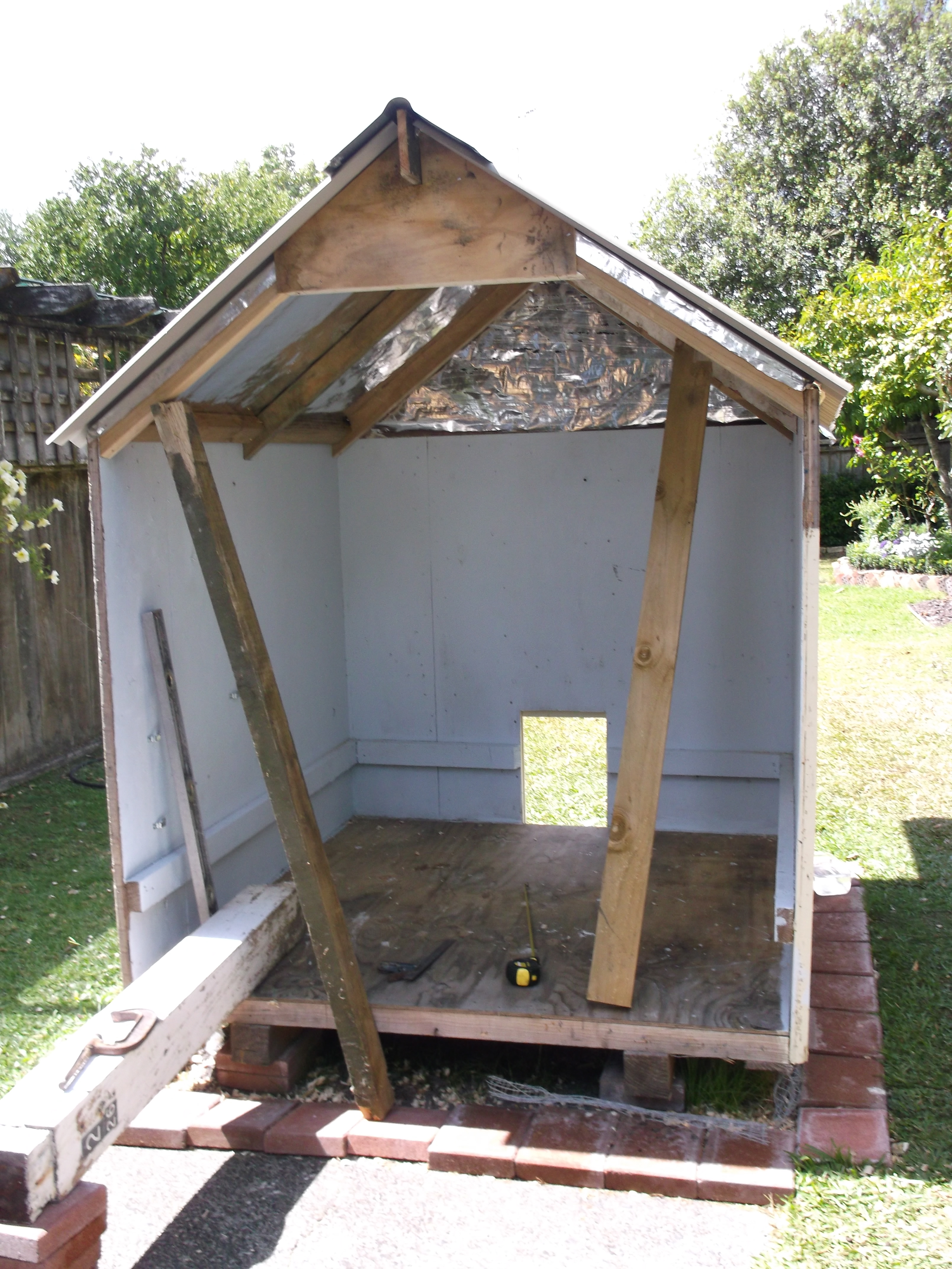 Silver insulation paper to prevent condensation from underside of corrugated metal roof.