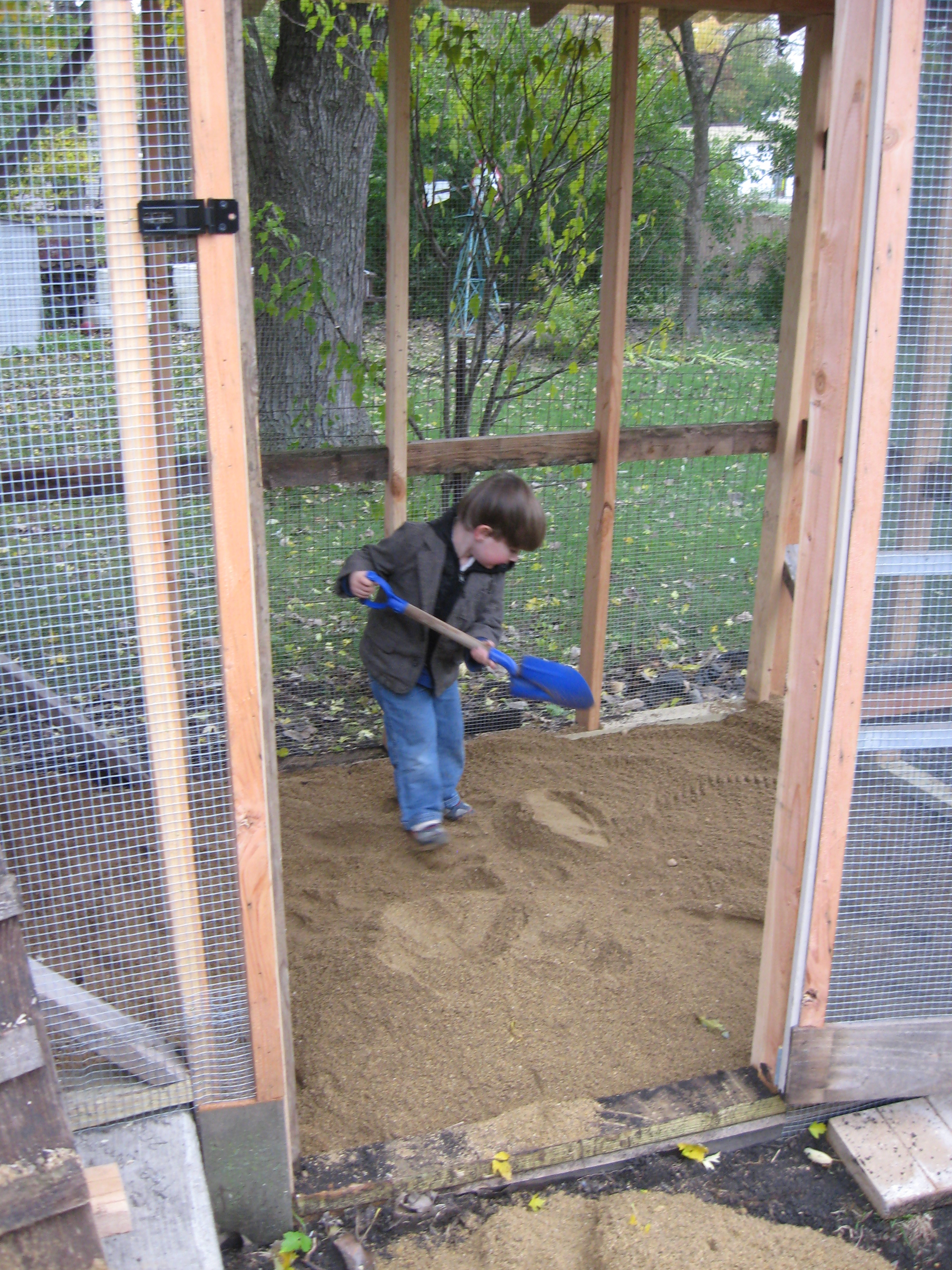 Simon helping add sand to the run
