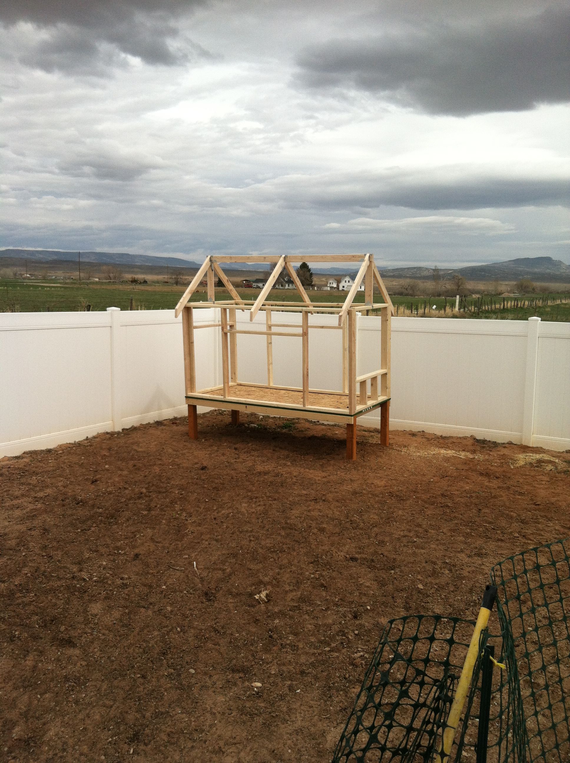 Simple design.  Raised a foot and a half off the ground to provide shade for the chickens.  Open eaves on both sides for ample ventilation.  Windows on both sides.  Drop down doors on both sides for easy cleaning.  Trap door on floor to easily sweep pine shavings underneath.  Use space underneath coop as a great composting area for the garden.  All built with 2x4's and 1/2 inch plywood.