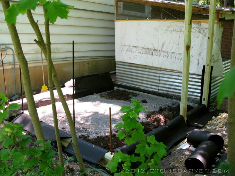 Since I had some leftover roofing felt, we wrapped the bottom two courses of landscape timbers for extra rot protection.