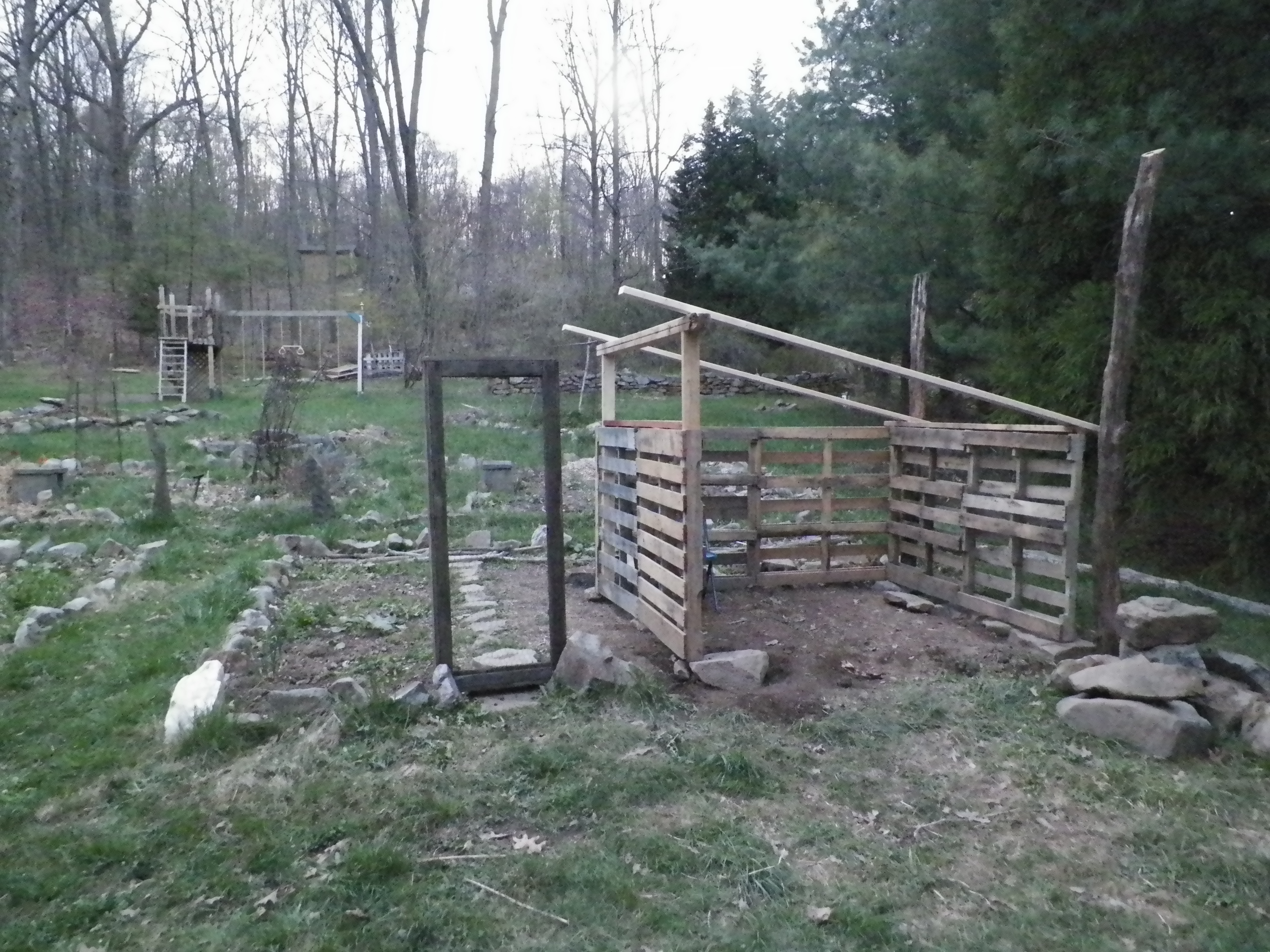 Some of the rough framing done and a old door frame from a demolished run is stood up where the run door will be.