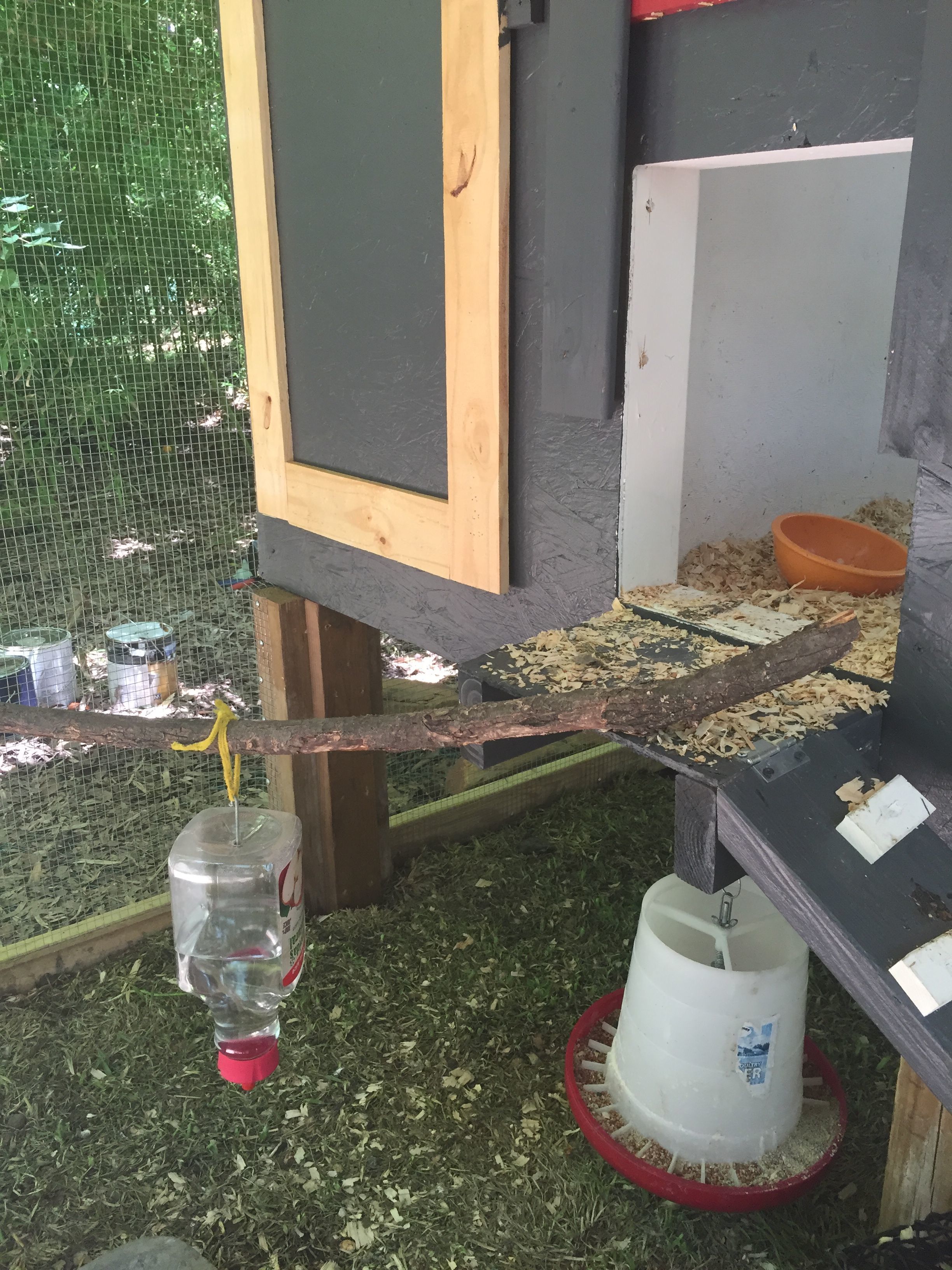 Storage door & chicken door. Feeder hanging underneath
