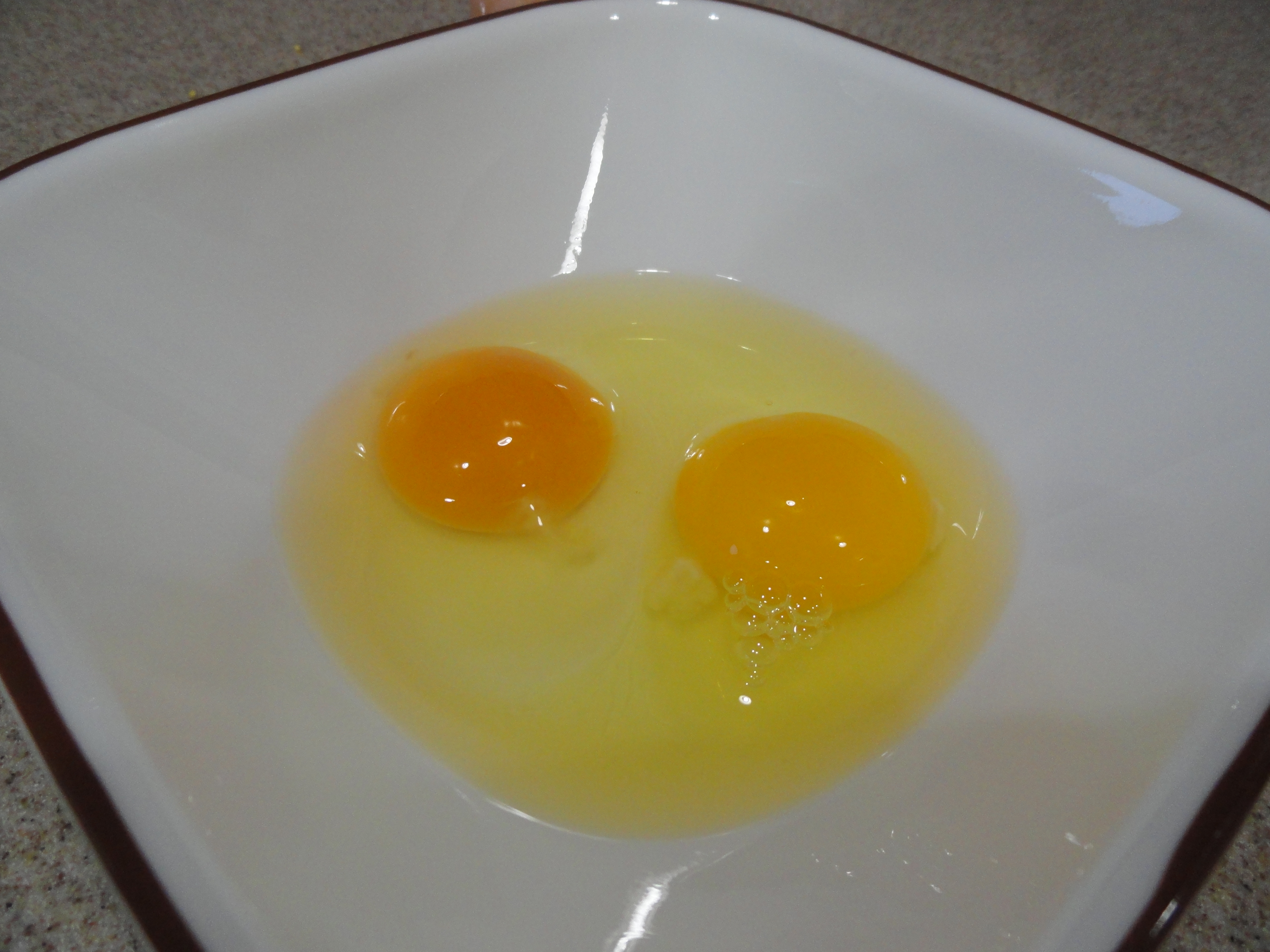 Store bought (right).  Backyard egg (left).  But you already knew that just by looking.