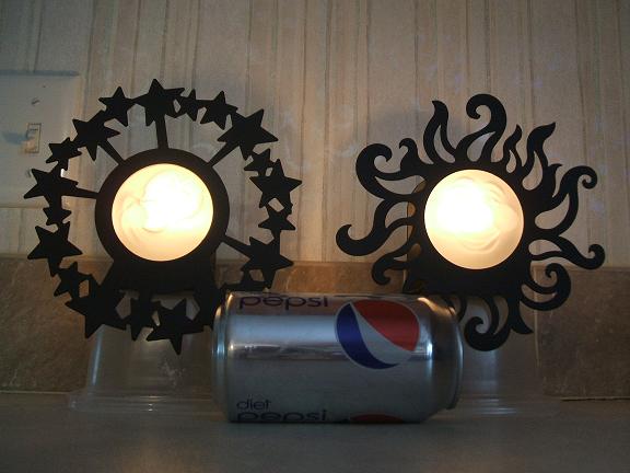 Sun and Moon candle wall sconces
black metal around the outside, glass smiling face in the middle
stick off the wall about 3" or so
The candles are lit and the room lights are off in this pict