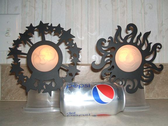 Sun and Moon candle wall sconces
black metal around the outside, glass smiling face in the middle
stick off the wall about 3" or so
The candles are lit and the room lights are on in this pict