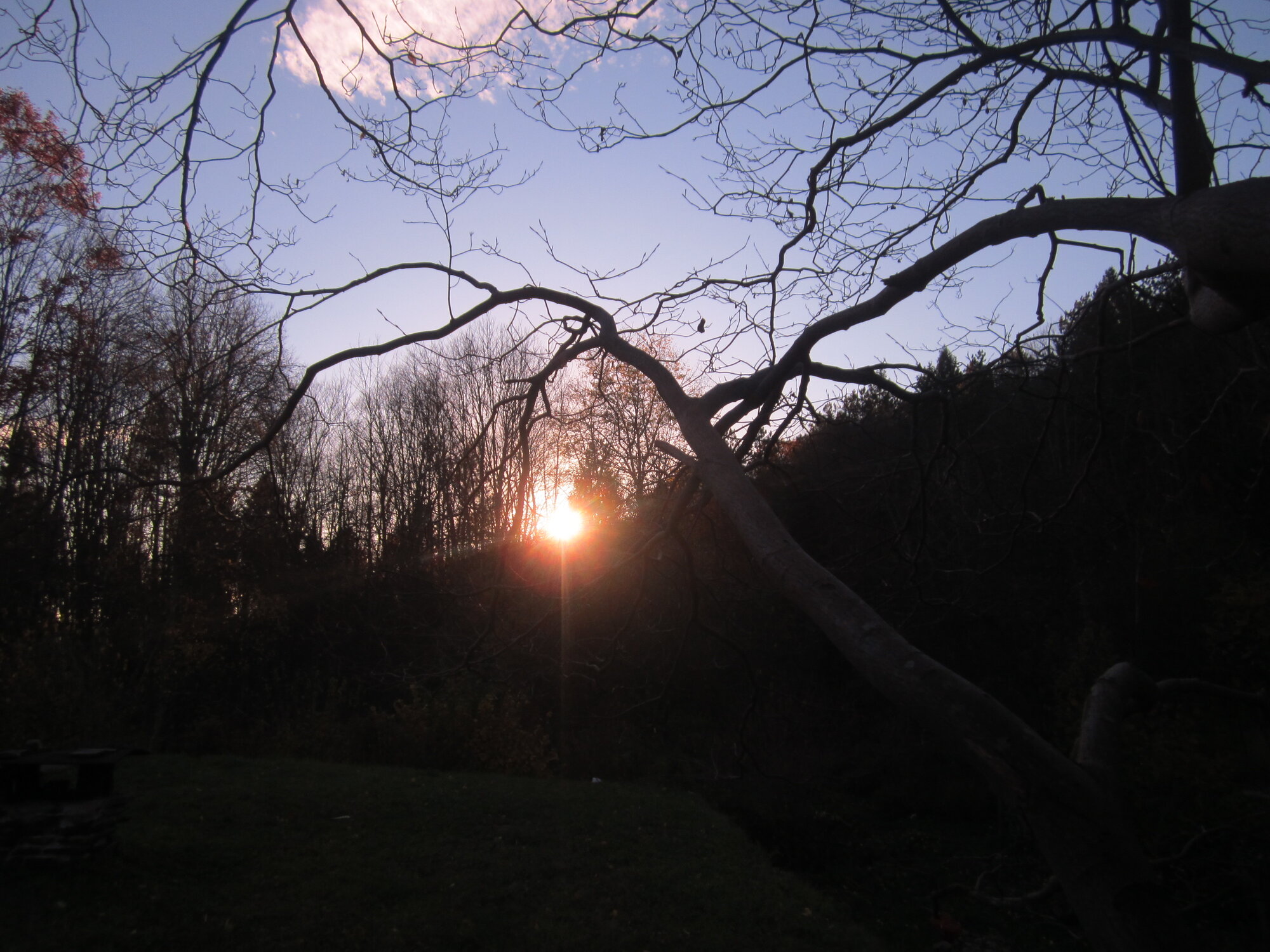 sun sinking below the hill