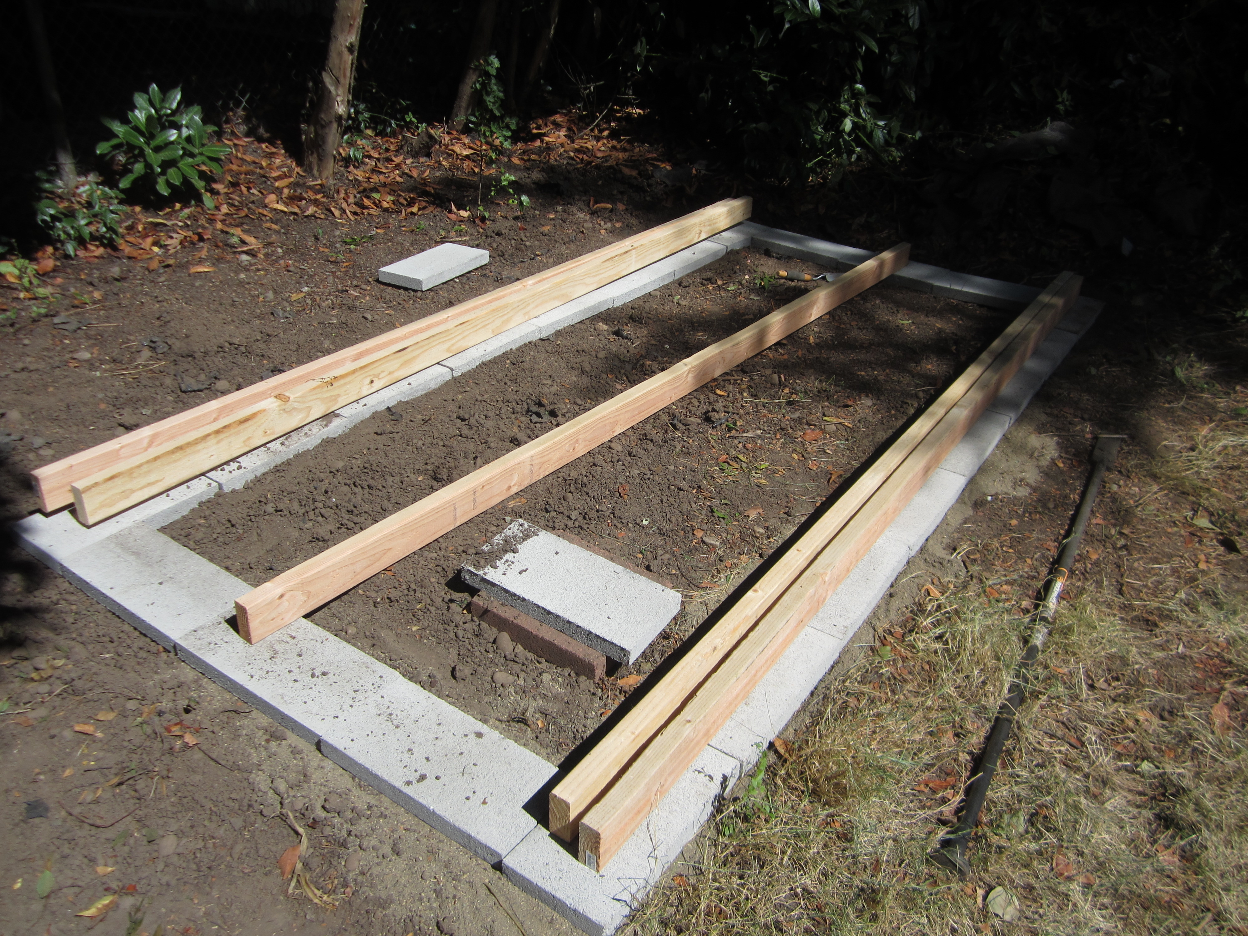The bricks for the base of the coop. **Originally we were going to dig the posts into the ground and it actually would have been better-you can see later that we had problems with the coop leaning that could have been avoided with just digging the posts in the ground instead.