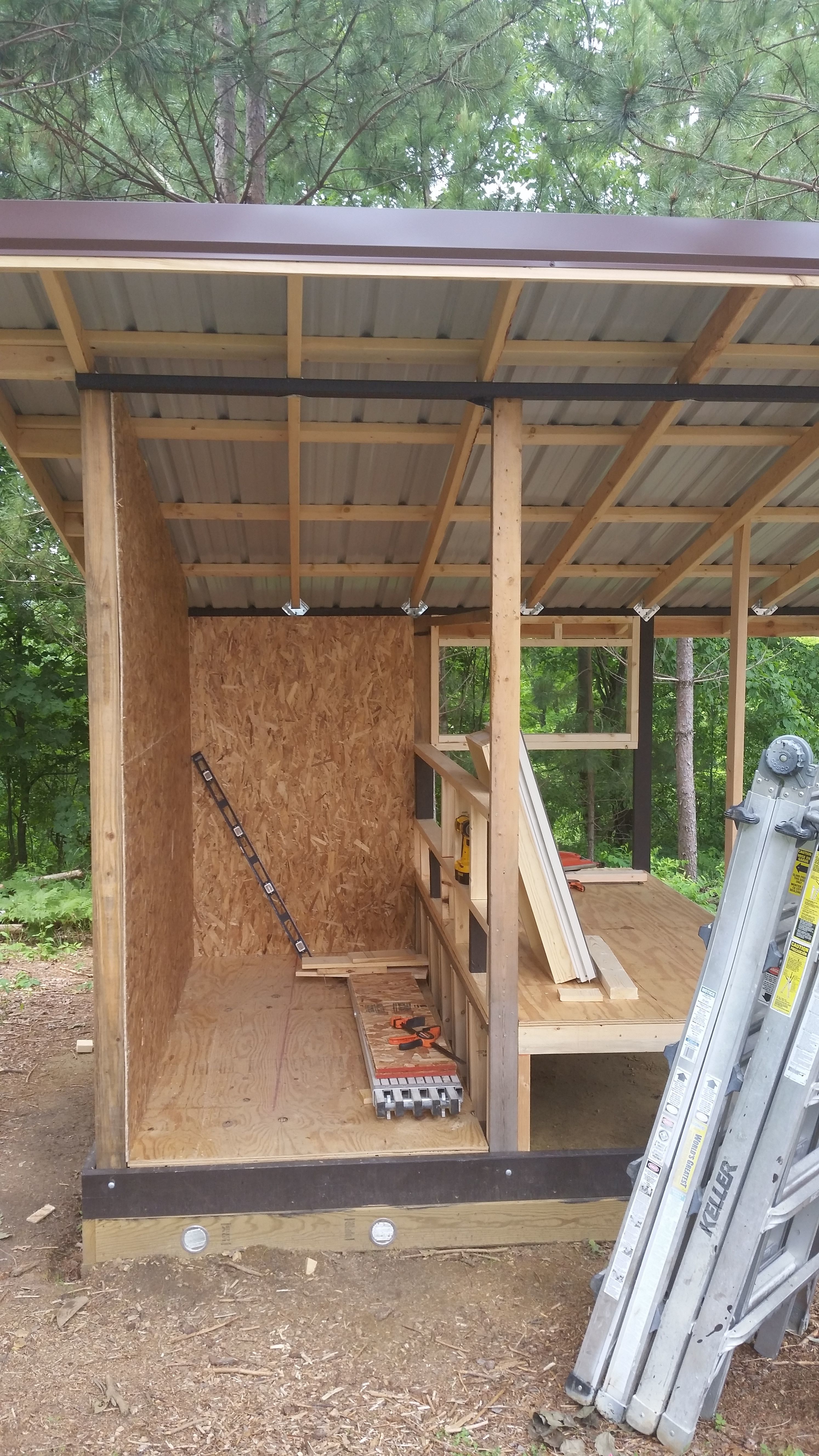 The building is 8X8, divided in to two 4X8 sections.  The tall  portion on the left is storage, and the raised section on the right is the coop.  You can see below, a couple of the vents added to the crawl space below storage.