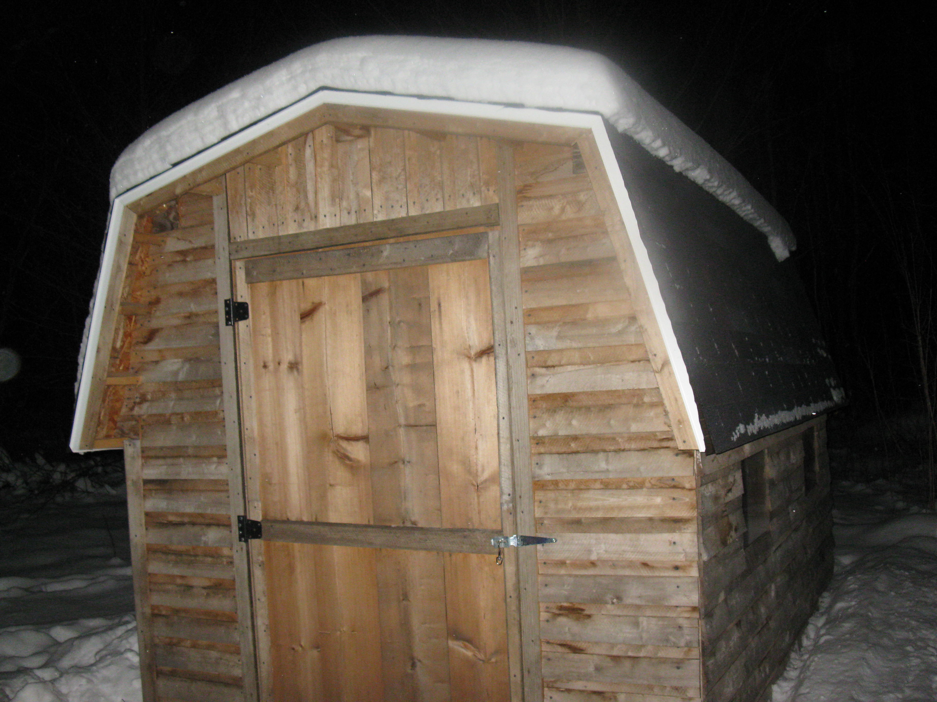 The Coop. The door is 1"x12" pine. It's 8 1/2' high @ peak. Just 3 tab shingles, you can see my southern facing plex-e-glass windows.
