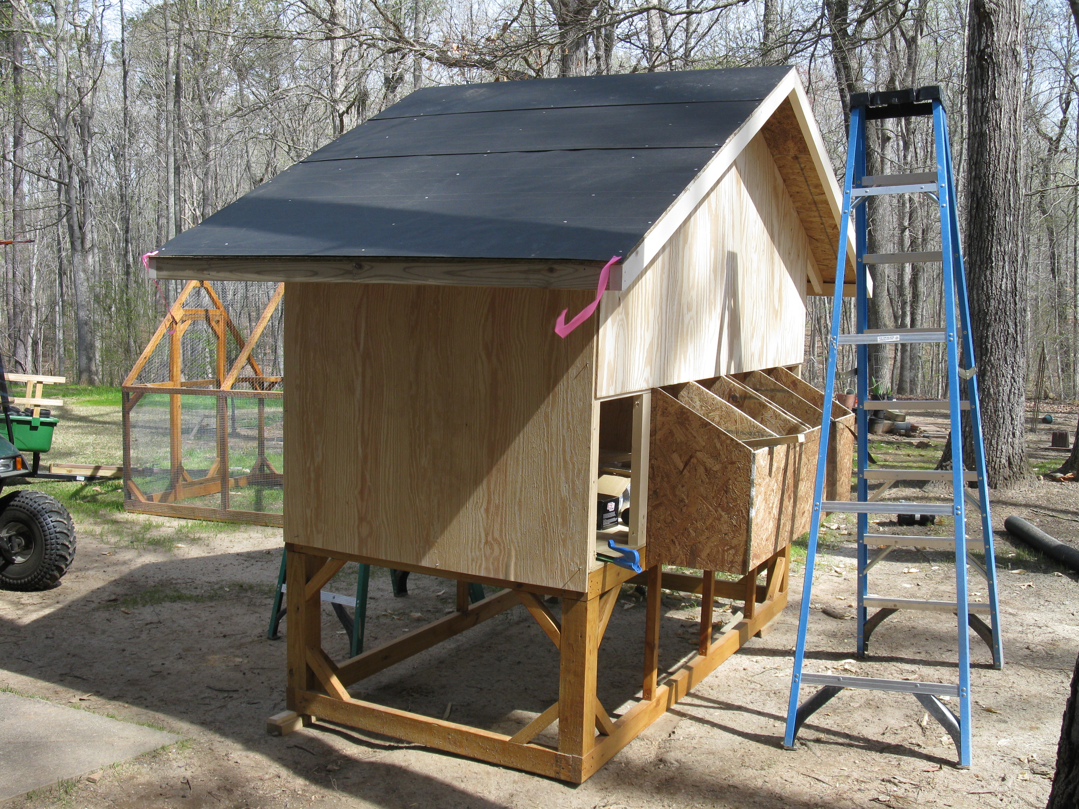 The coop under construction.  I didn't really have a plan.  Looked at alot of coop pictures and built what I thought was going to be a tractor but ended up being pretty heavy.  I have a tendency to overbuild.  Used 3/8" exterior ply for the outside with mostly 2x2 framing and 2x3 rafters.  Floor is 2x4 and 4x4 with 3/4" treated ply. The nest boxes are 7/16 OSB framing with 3/8" exterior skin. Dimentions are 4'x8', sides are 6' from floor to top of ridge and 4' from floor to bottom of room on the ends.