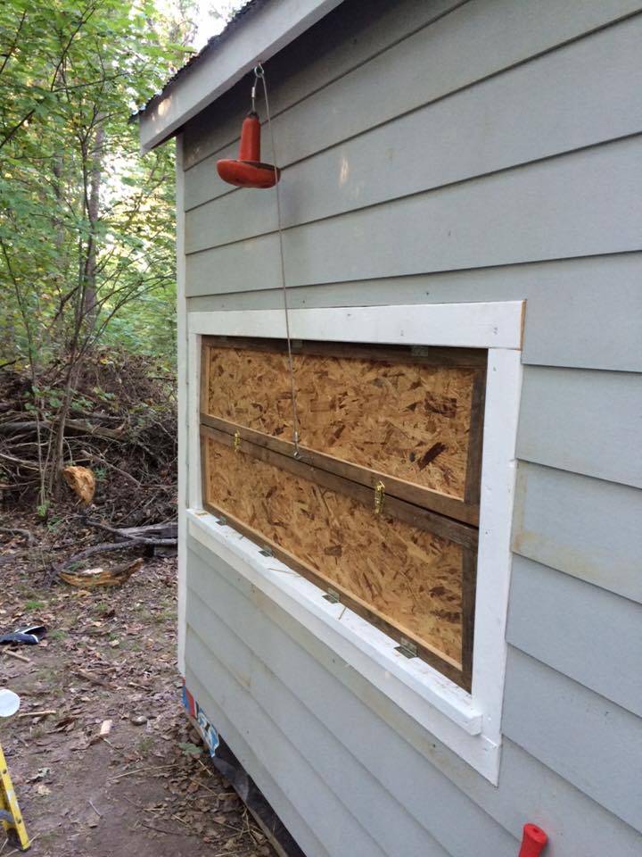 The doors to the nesting boxes. Notice the old boat anchor? When the top door is raised it lowers and hold the door up.