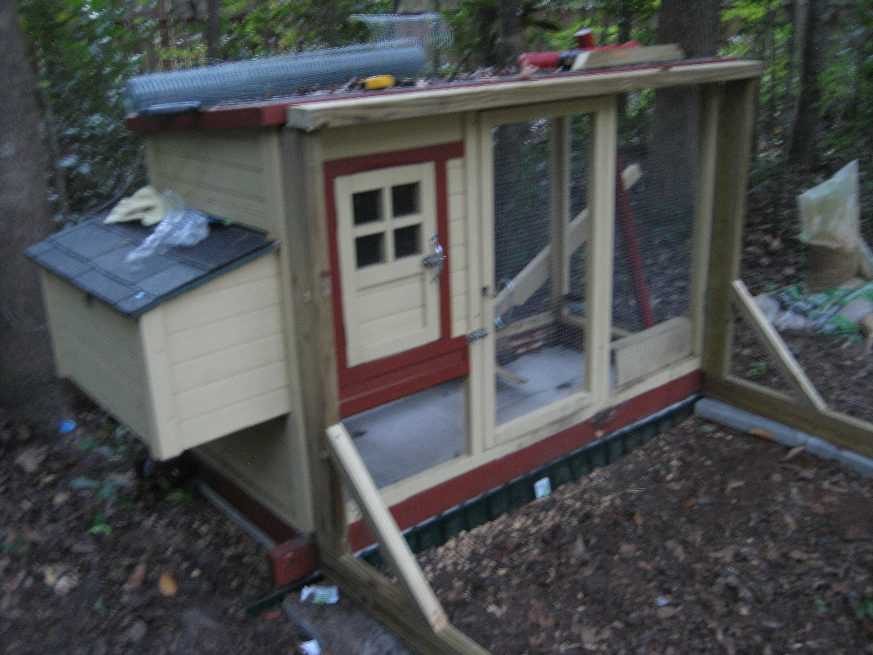 The frame is attached to the main coop with screen door type latches. Not that it's going anywhere - and probably doesn't need to be attached because it's too heavy for any animal except like a bear to move it (not much chance of that here!). But we can detach and move it if we should decide that we'd like to reposition the whole setup some day.