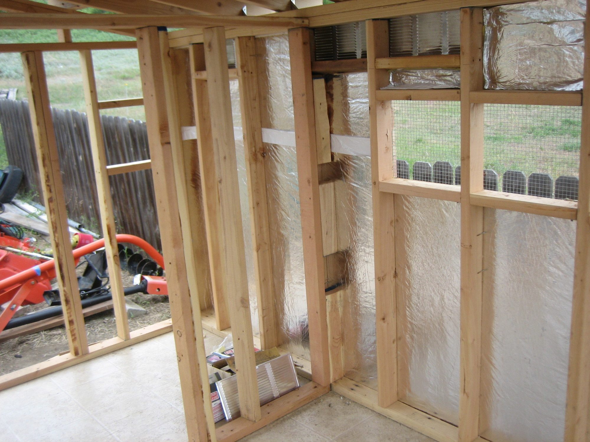 The interior wall separates the coop part from the food & storage part of the Shack.  We used some weather barrier around the outside of the Shack that was left over from our barn project.  The walls and ceiling are fully insulated using leftovers from a "buddy's" remodel project.