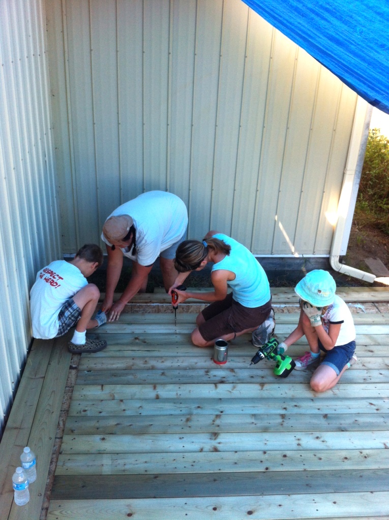 The kids and I finishing the floor boards so we can get going on the walls