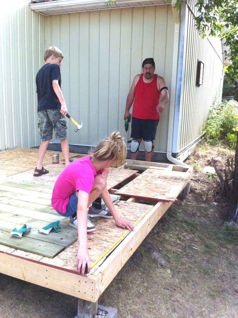 The kids "helping" screw in the flooring panels