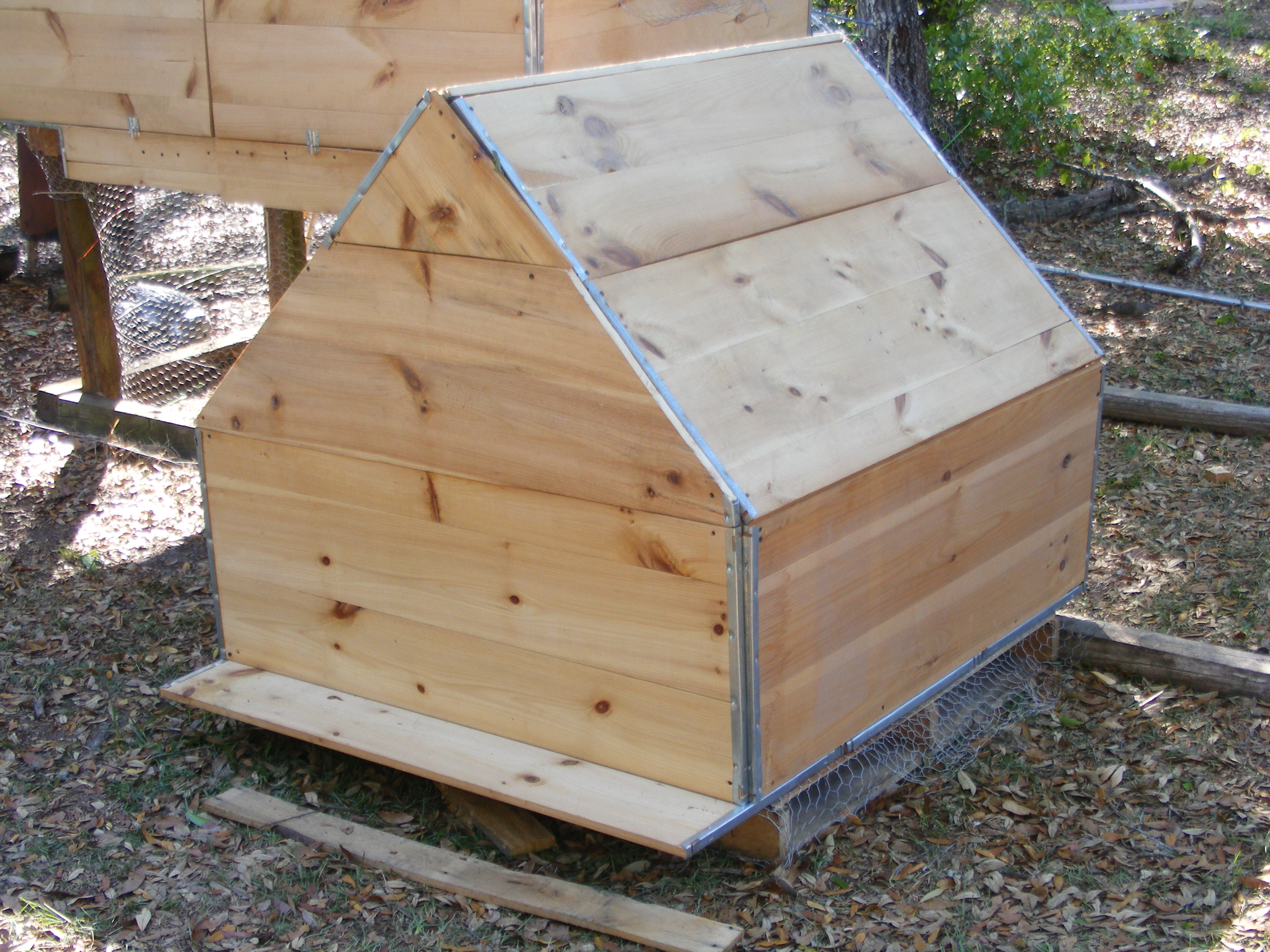the last coop I built out of old white pin store shelving we picked up from a flea market for $2 a shelf an old palate is the base we used old 4X4s to outline the coop yard we used old pvc to support the chicken wire other then the cost of Chicken wire this coop cost $33 will take current pics soon with the roof complete but still need to paint it.