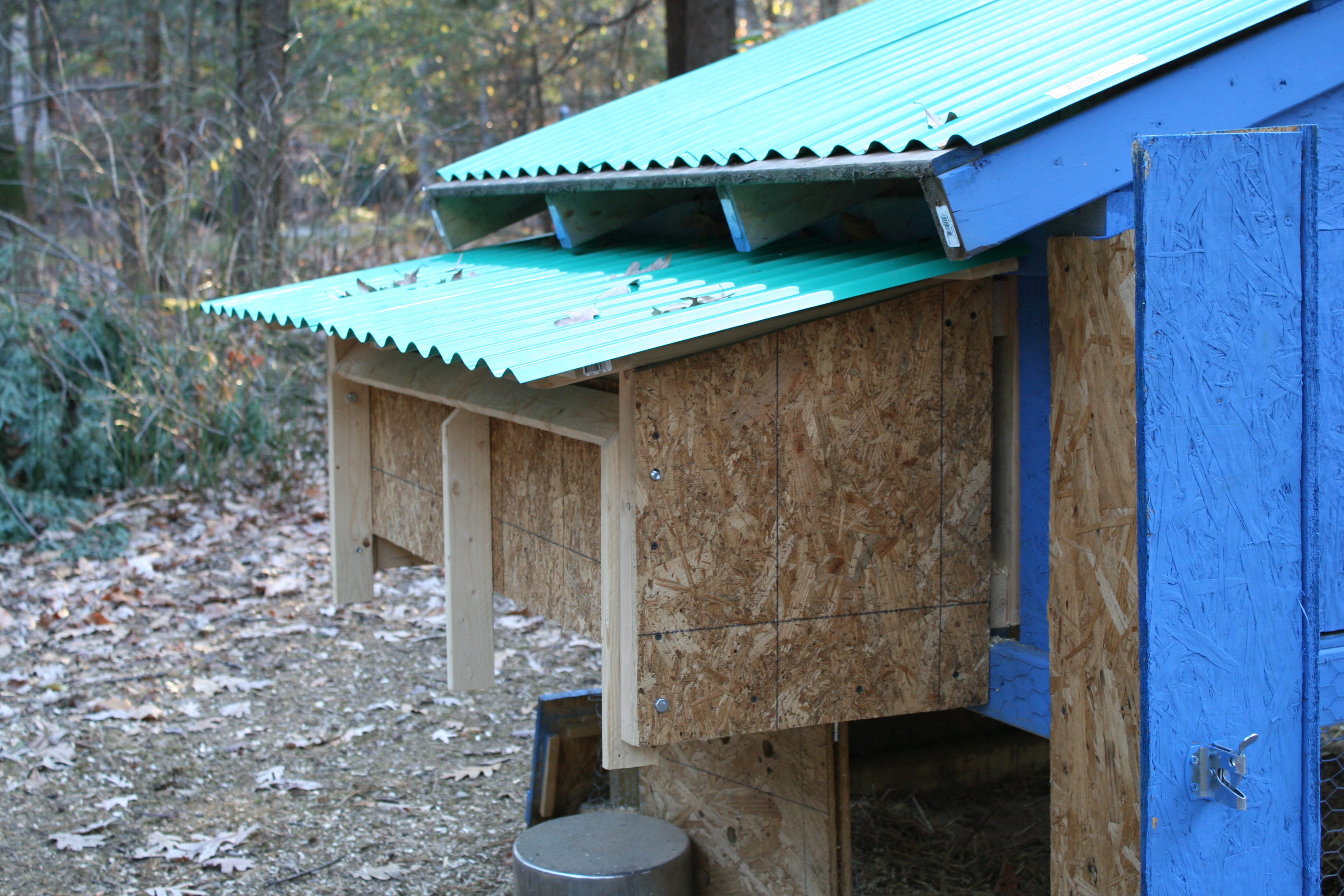 The nesting box on the back of the layer coop.  We had to rebuild after the first nesting box sprung a leak.  We also discovered that our barred rock girls needed a bit more space, so there are three boxes instead of the original four.  The whole back opens up.