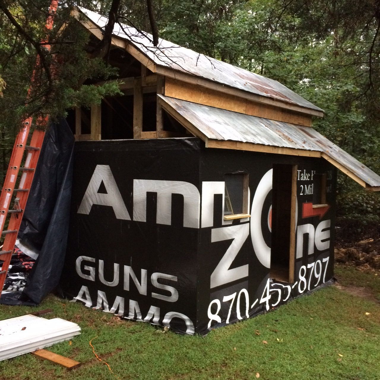 The rest of the rafters are on, as is the metal roof. Inside all the nailers for the trim and siding are also in place. I had just enough scrap plywood to sheet the back wall. Now making good use of an old vinyl billboard before we put up the siding. That will work as insulation and help keep any draft out. You can see where I extended the roof in the back corner. That will keep some of the rain out of the chicken door.