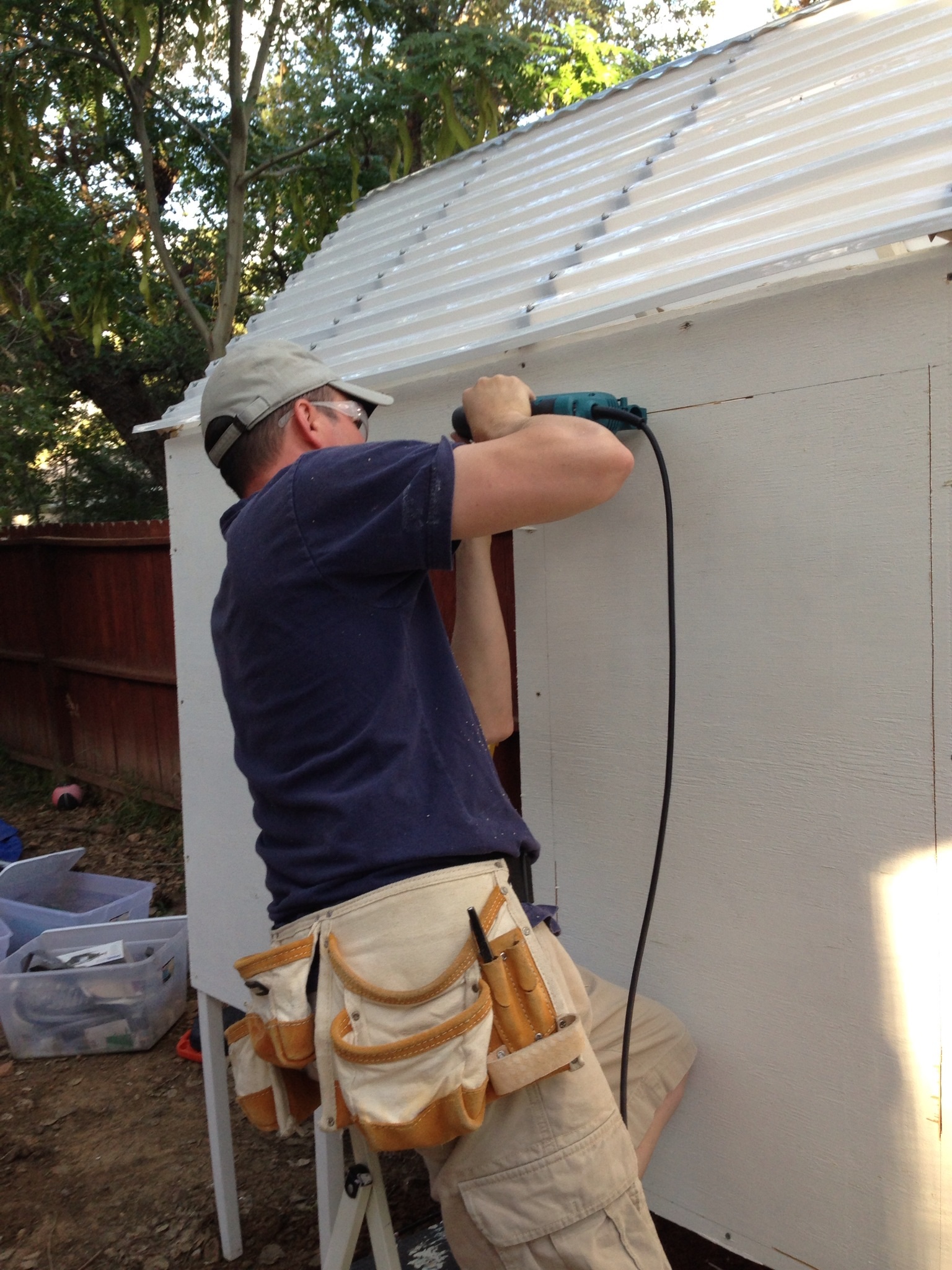 The roof & the walls were installed & my husband cut a large door on each side to afford easy clean up & pick up of birds