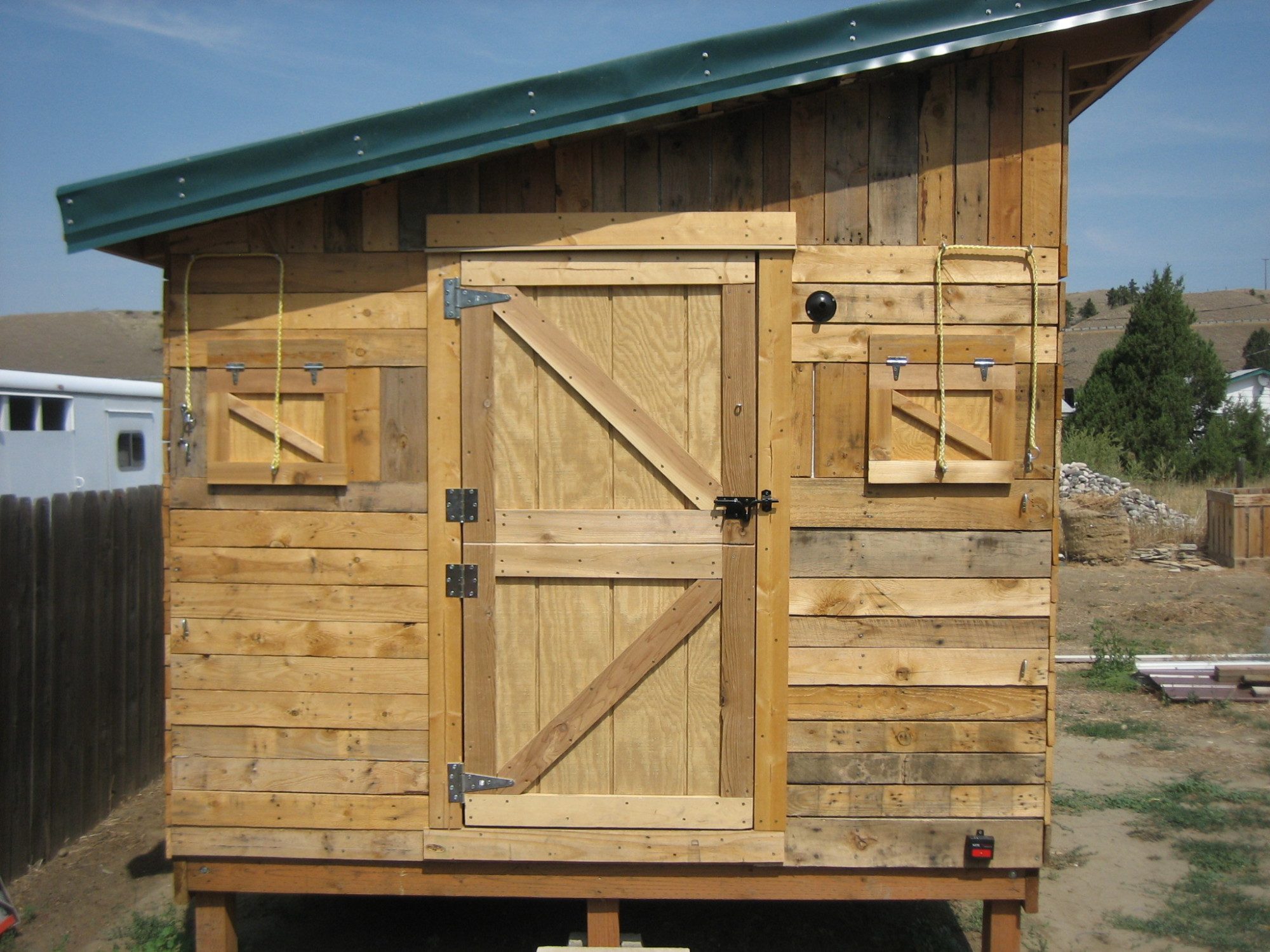 The south side of the Shack with 2 shuttered windows that open from the outside and the Dutch door I made.  The door is made out of some left over siding from the house.