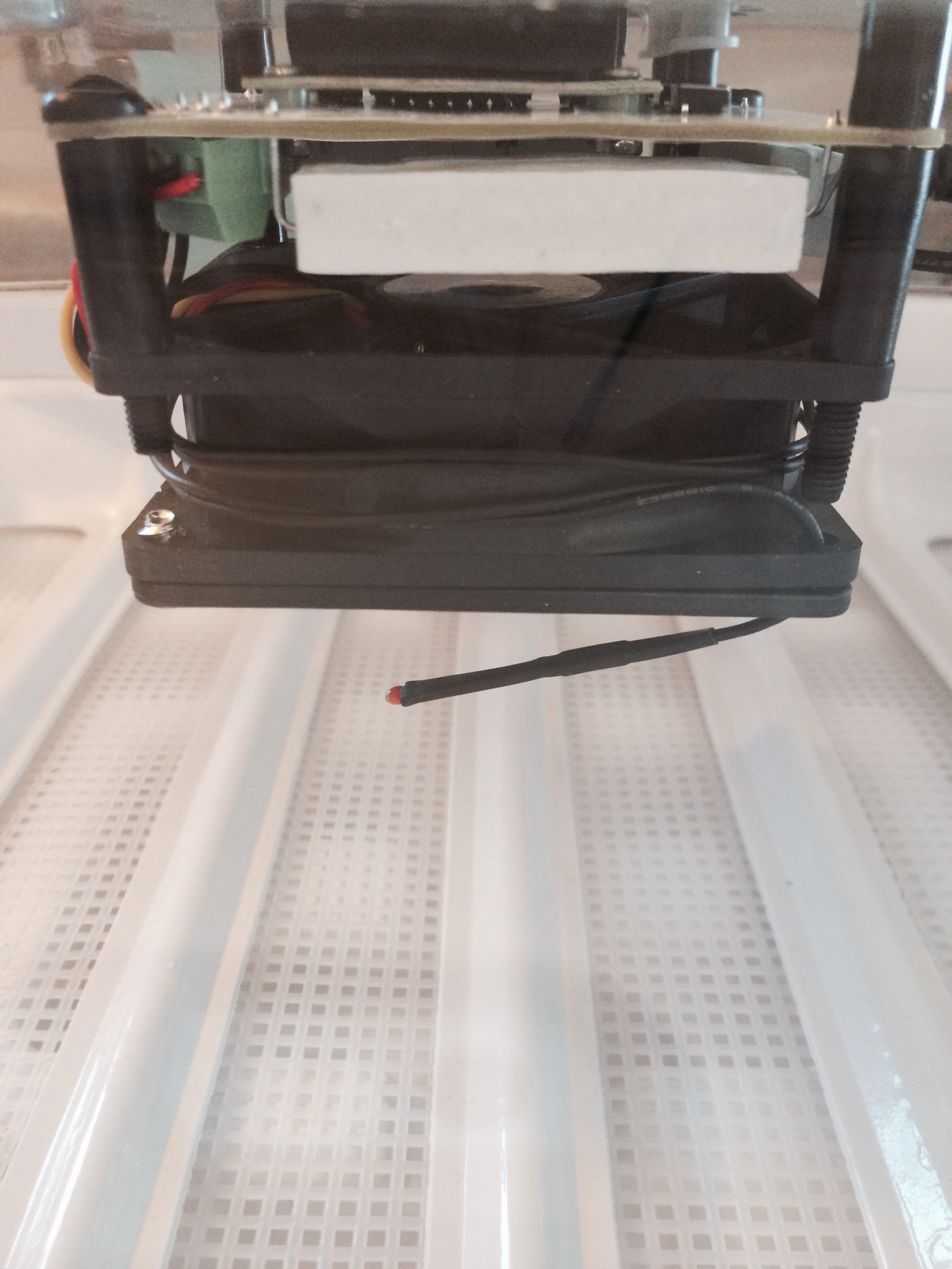 The temperature "probe" that sticks down below the motor/display. It appears to have a very long cord that wraps around the fan. I'm not sure why the cord is so long. Is it so people can put the probe in a different location??