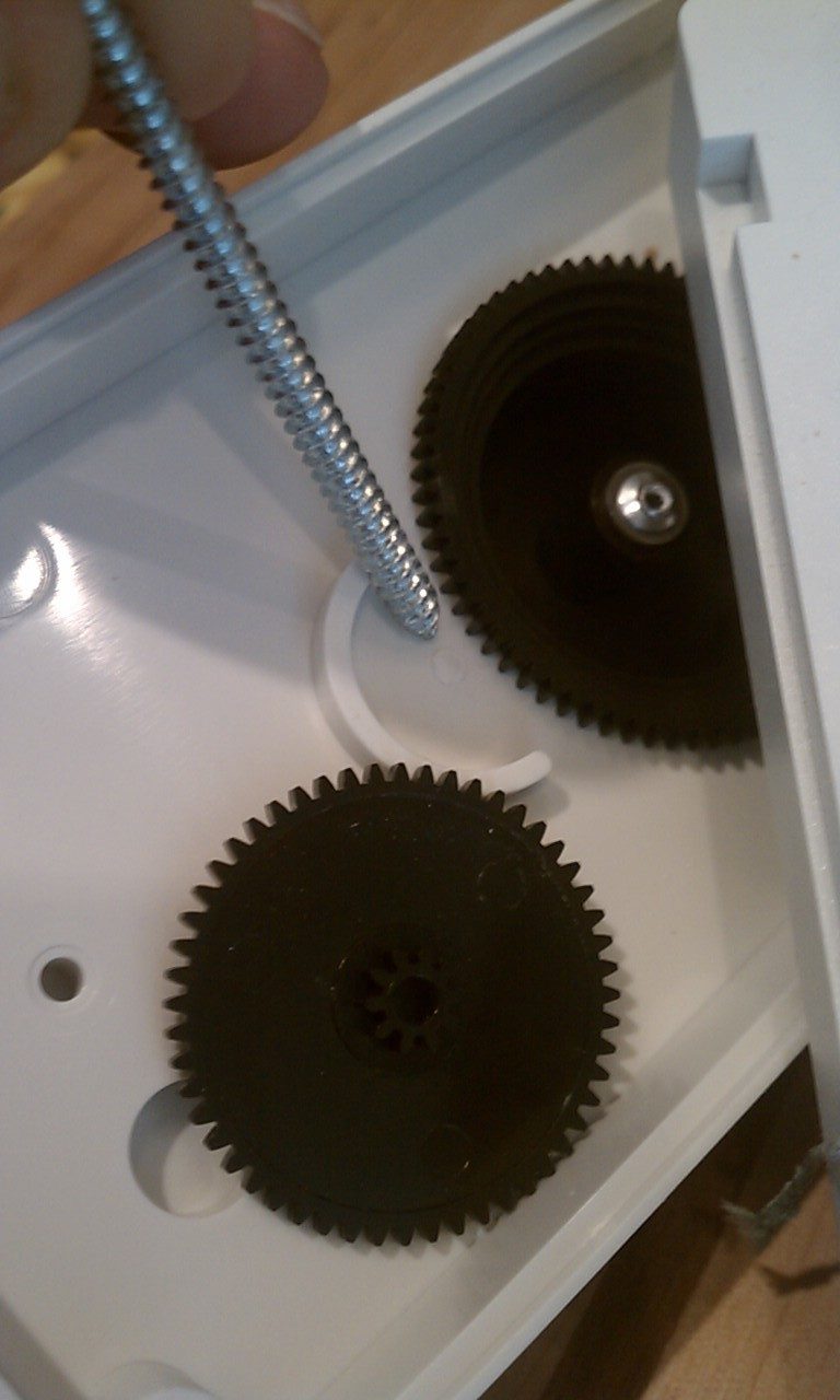 The tip of the screw indicating where the plastic post that held the gear in place was located.