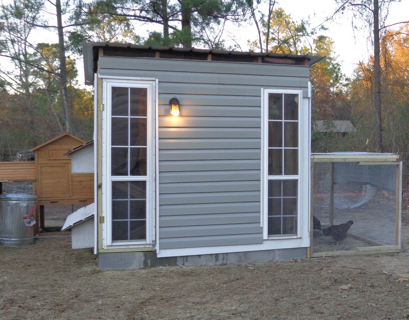 The window on the left we framed and used as a door.. Picked up the two windows for $20. couldn't go wrong with that....