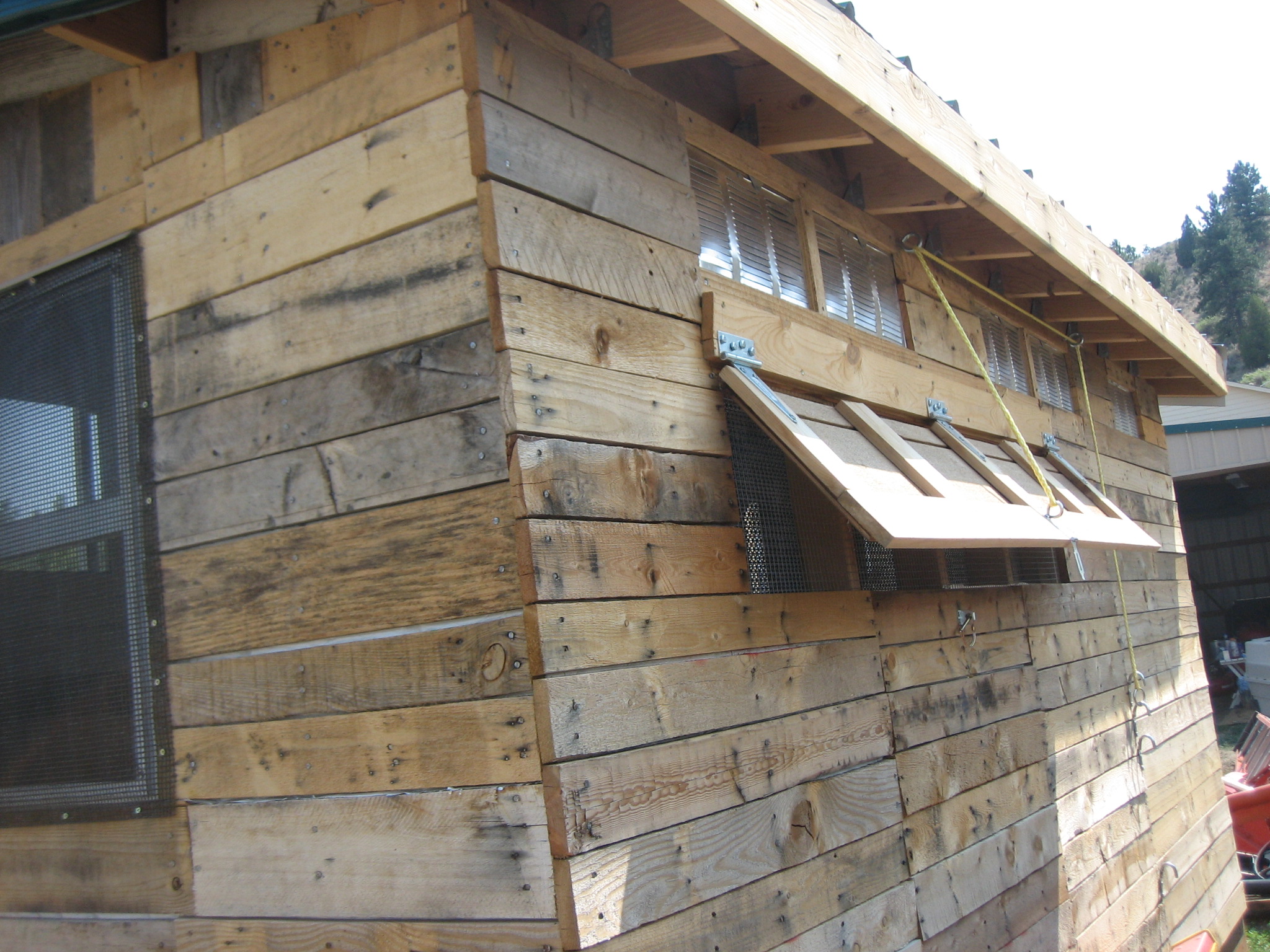 There are 2 glass windows in the shack and 3 shuttered, screened windows.  On the back side we put in metal air vents from Restore so there is always ventalation, even if all windows are closed.  There are lots of cracks due to the pallet planks being uneven, we are filling the cracks with log home chinking.