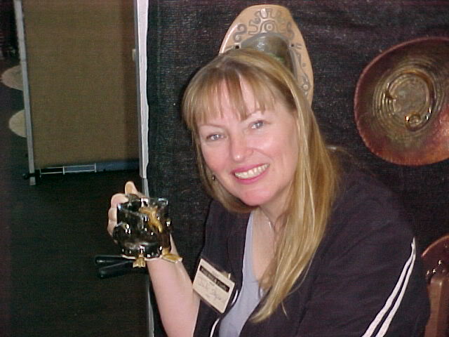 This hand made chicken mug was inspired by our pets. Here I am at as an artist/demonstrator for a show at Oakland's Crucible back in 2005, thus the name Artpeeps. a Peep is a friend in Jamaican. It is also a baby chick and a spongy marshmallow chick that is sold every year around Easter. So everything related to Peeps Candy became our mascot as well. We collect all items that say Peeps, to include T-shirts and mugs. Our house logo for Artpeeps features a French chicken holding a painter's palate and paint brushes.