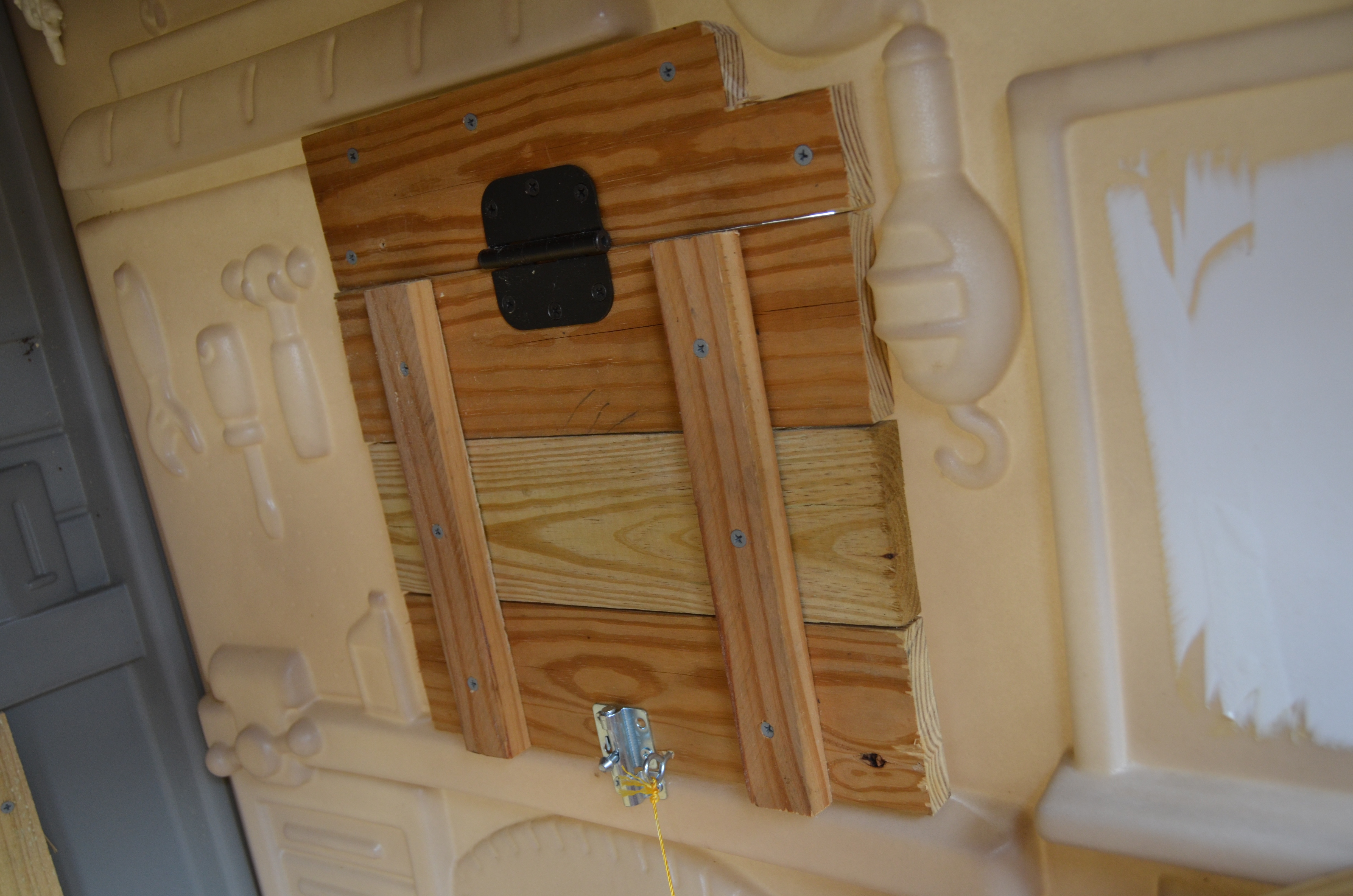 This is a little door that pulls up so they can get in and out if the front door isn't open.