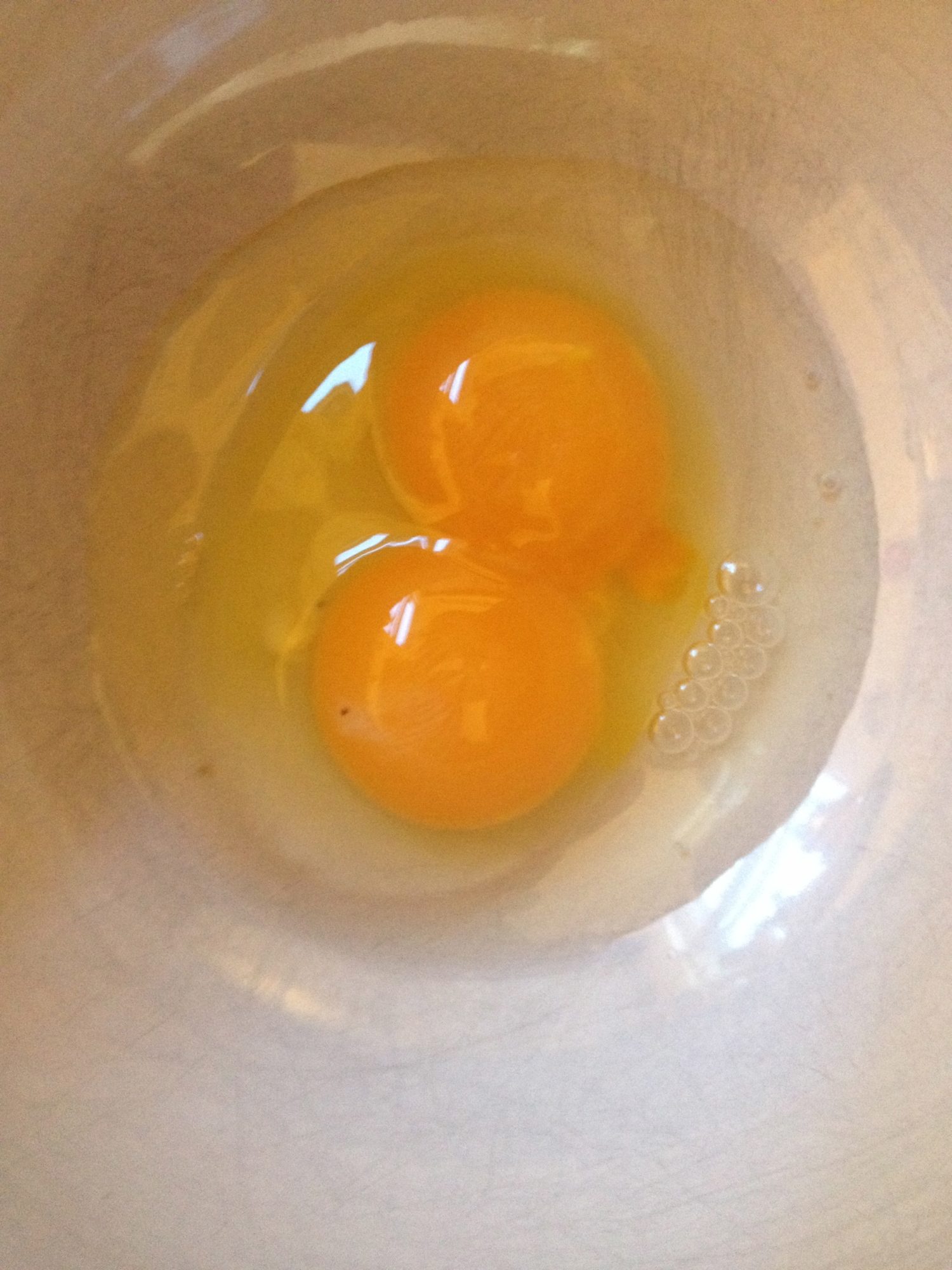 This is Red (one of our Red Stars) first egg. Bright Orange Double Yolk!