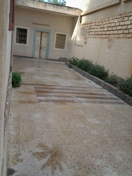 This is technically the front porch. Its the courtyard. The door at the end is a storage room or family pantry. I want to paint it vivid colors and put in potted plants. The green growing are henna plants. I had roses there but my mil watered them with salt water and killed them.