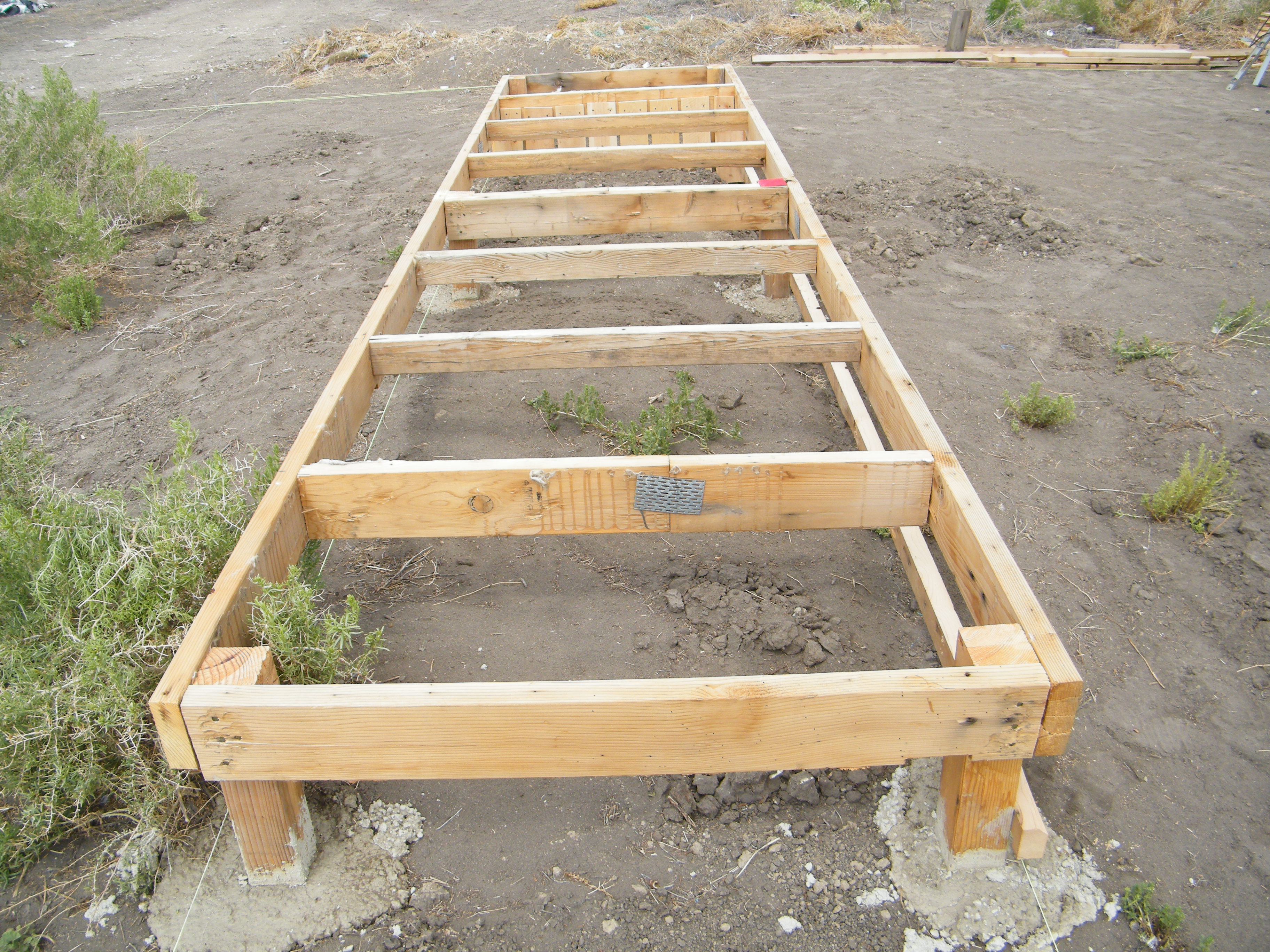 This is the frame work for the bantam stockade.  It measures 4' x 16' and will consist of two 4' x 8' pens including a 3' x 4' spare rooster pen in each end.

I should mention that all of the lumber used, so far, has been recycled with exception of the 4x4 posts and the wood fencing that will be apparent in photos to come.