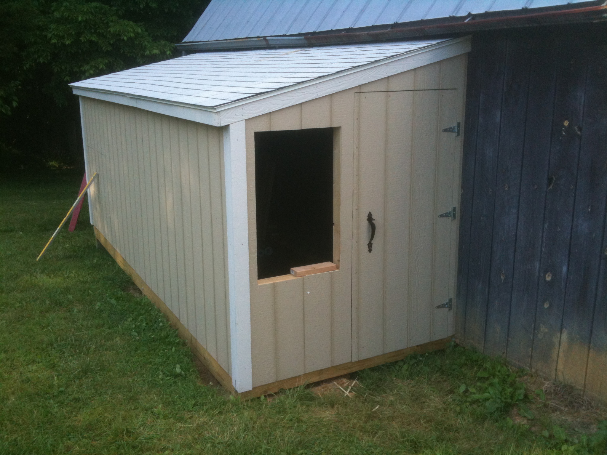 This is the front.  There's a people door and a window.  Bought some storm windows to use there.
