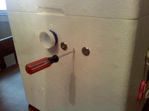 This is where I can adjust the water heater thermostat without opening the lid. Also the other pill bottle to allow for ventilation.