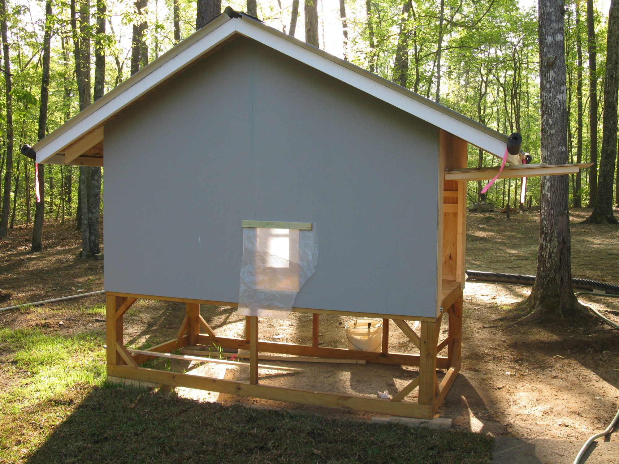 This side is the run side.  The chicken door slides up and down and is connected to an automatic coop door.  Works like a charm. I'll add another photo of the inside of the chicken door to show the workings of the auto door at a later date.