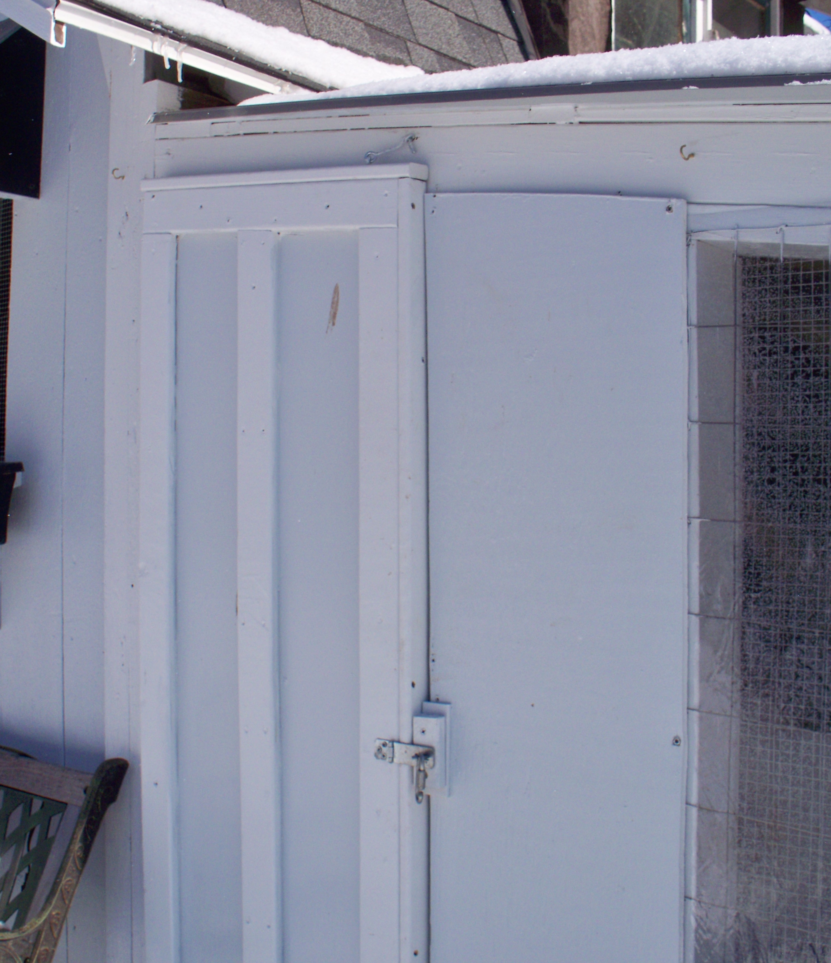 This small door is nice access from the front and gives me flexibility when I want to section a space off for broodys and young chicks.
The latch is secured with srew down chain type link. I also have a hook and eye at the top. The door itself is tight fighting and would take a little work for prying predators to open.