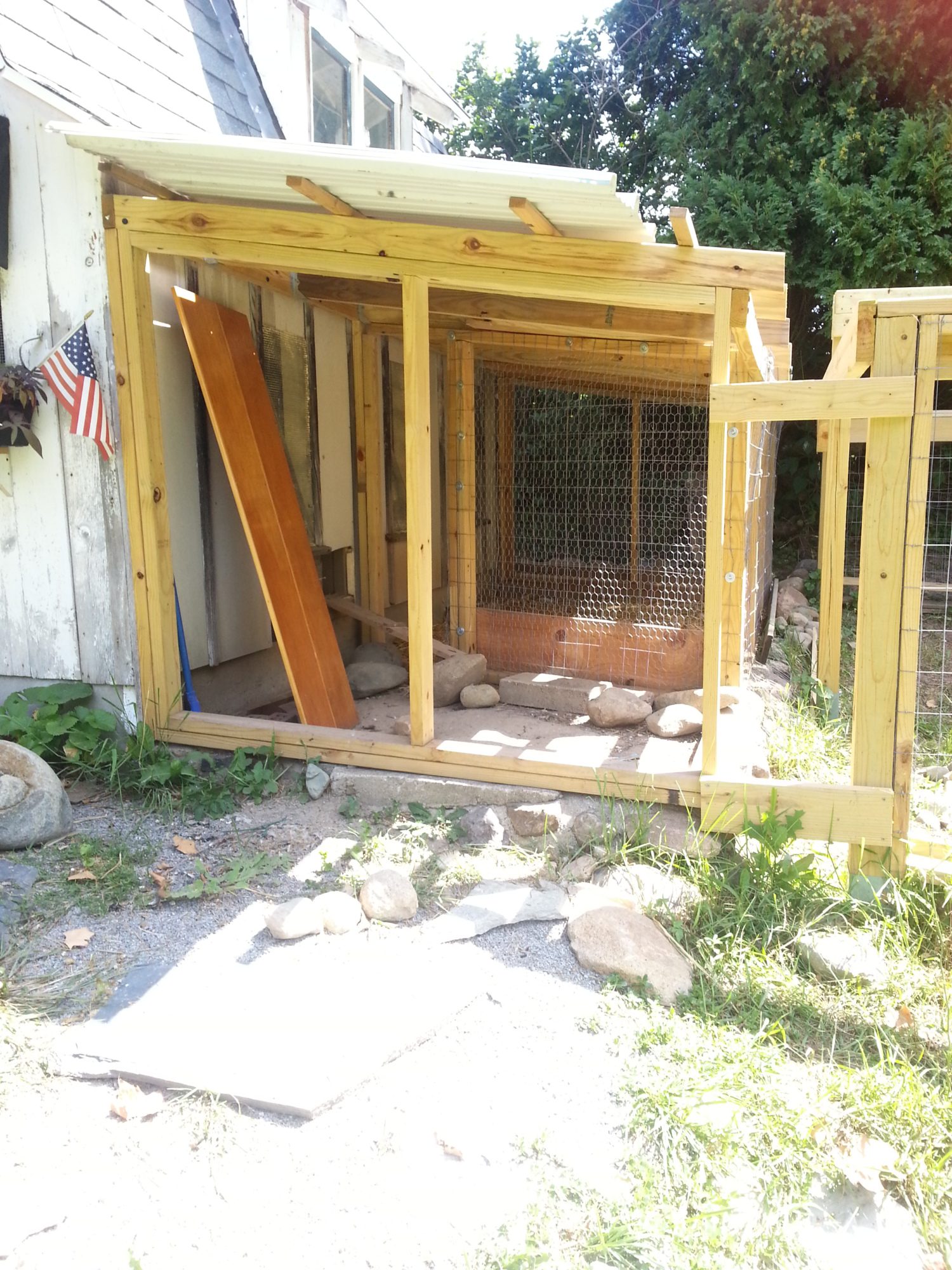 This small run, 5 x13 1/2 ft, is original square footage with the "barn" . The original builder/owner used  a stone foundation to keep predators from digging. He had hole in the foundation for posts and chicken wire. I have added a frame (and a roof.)