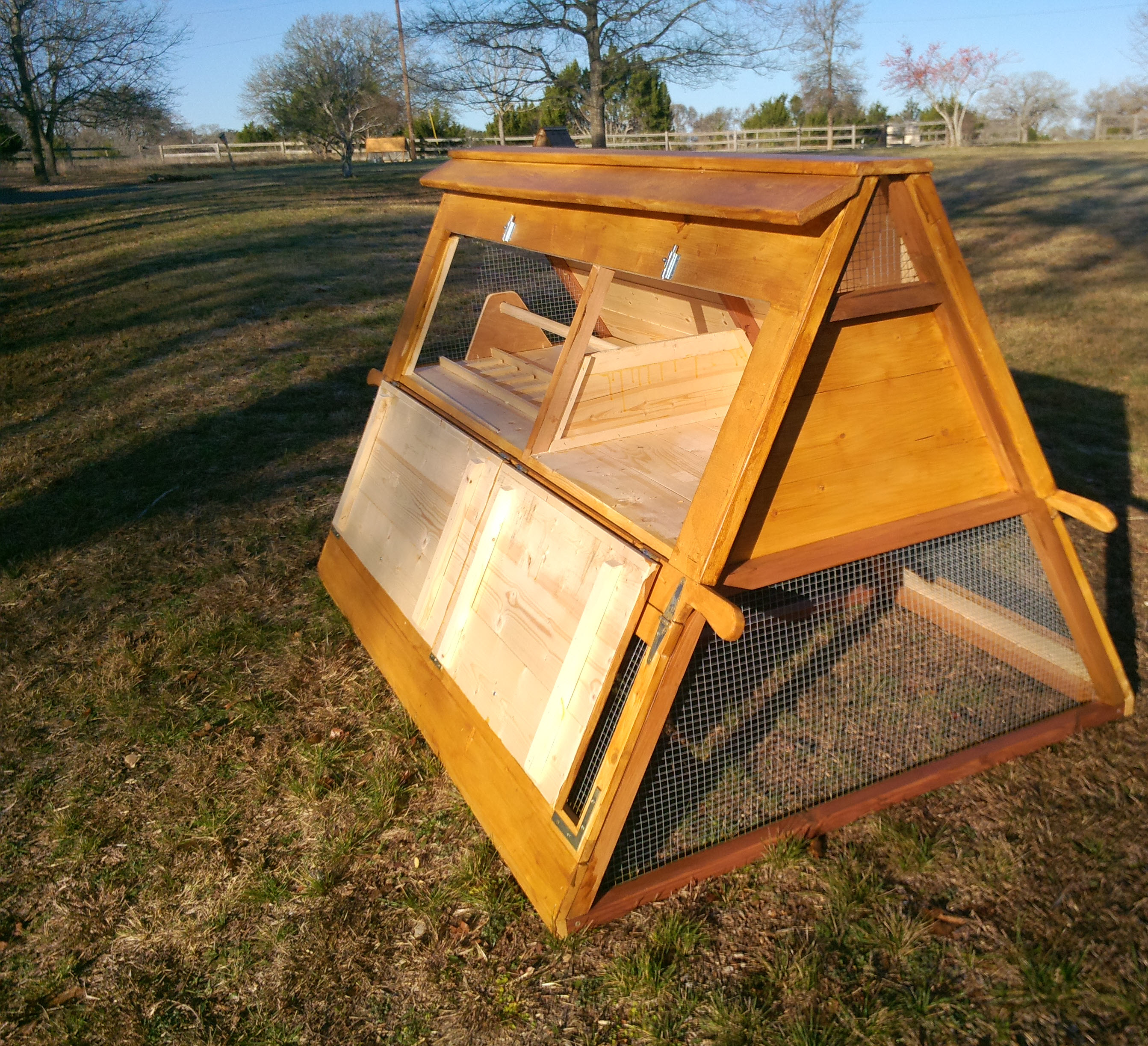 Top doors opened (side, roosting area and nesting box).  You can see the other small coops in the background.