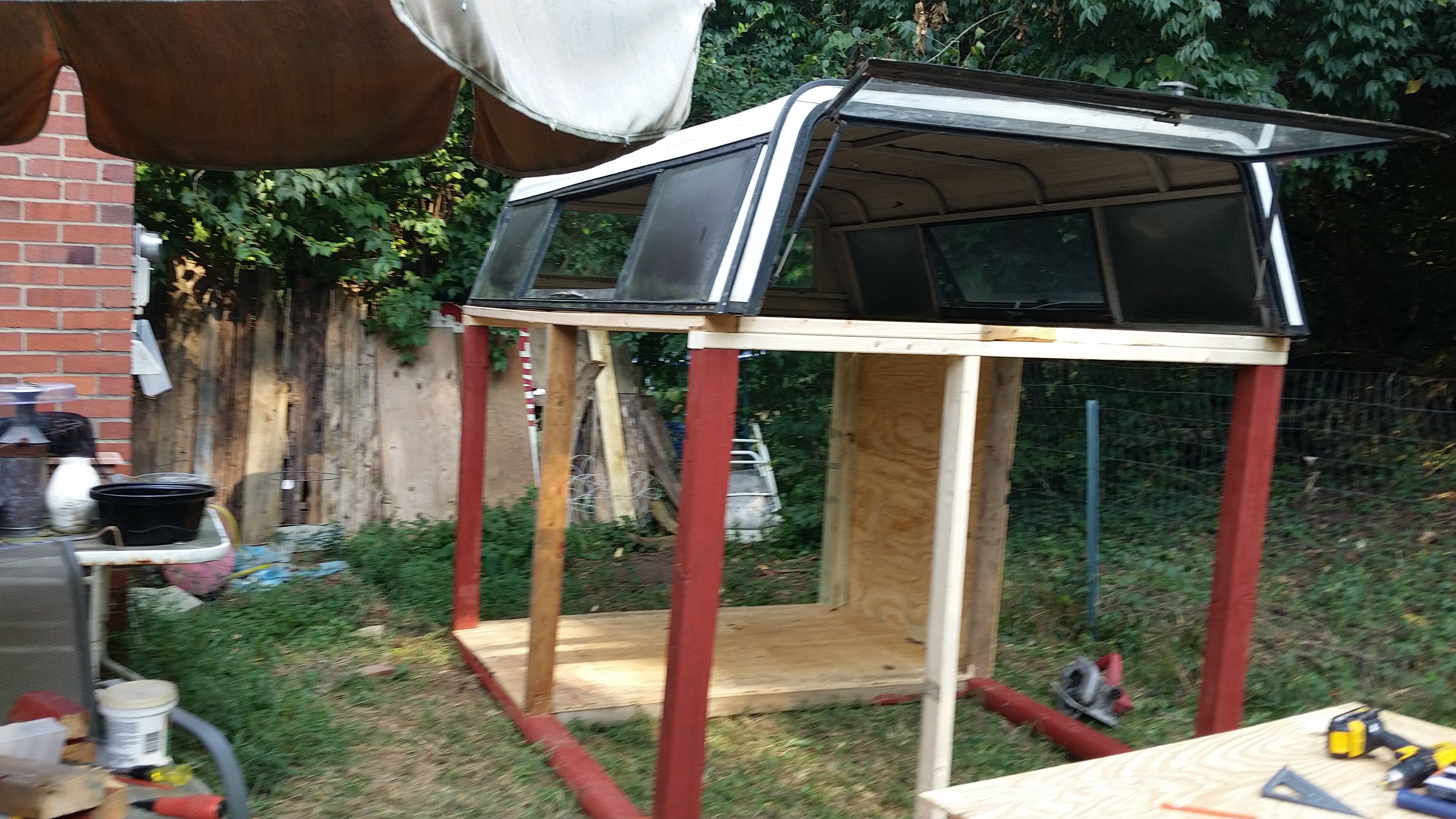 Truck bed camper top is on the chicken coop!