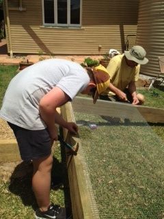 Us flipping the framework back onto the right side onto the road base we have layed out.