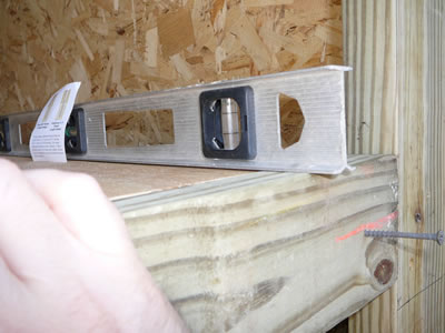Use a level to make sure 2x4's stay even with plywoodf flooring.