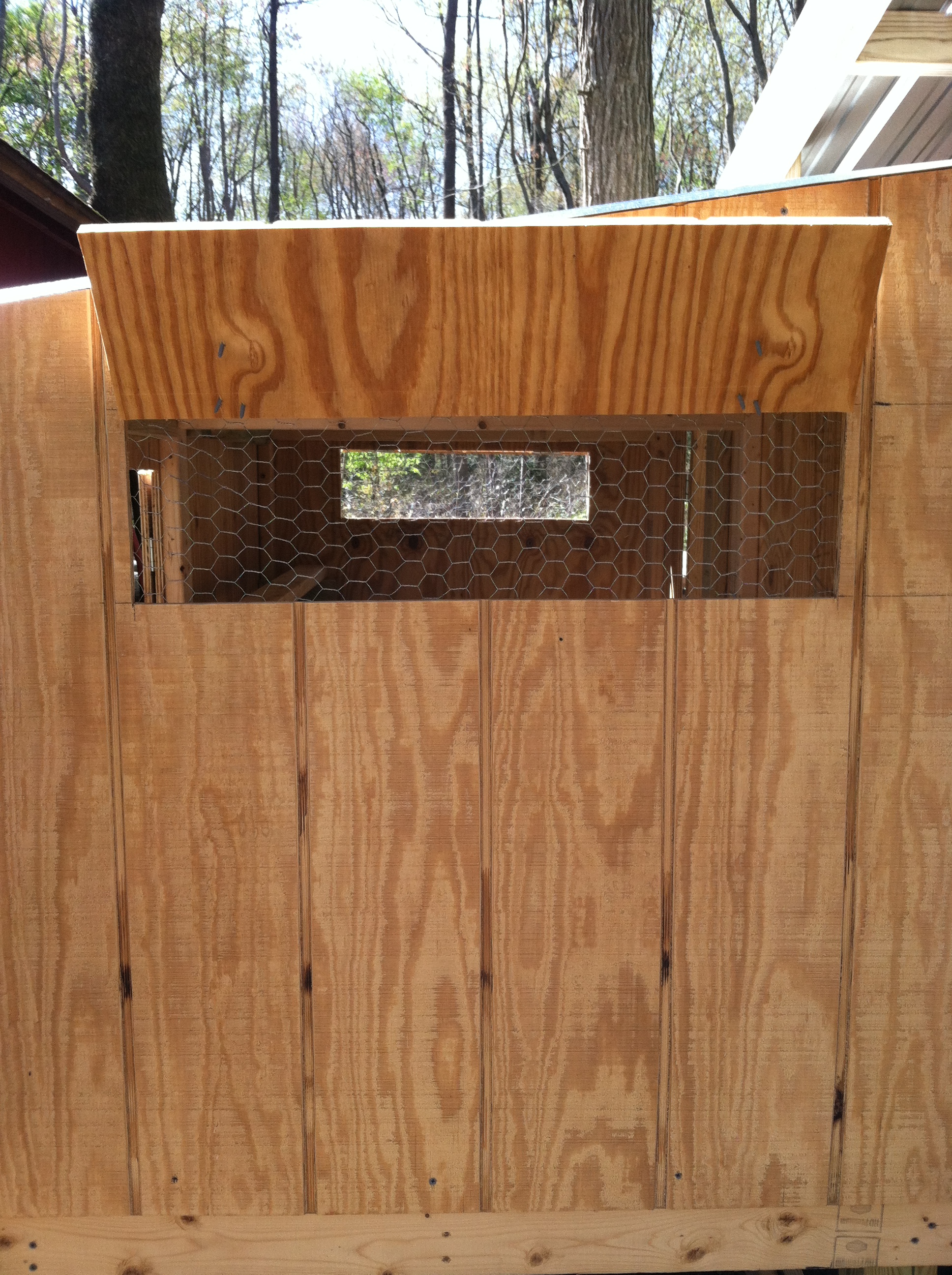 Vent windows on ends of boxes. Held open by hook & eye fasteners.