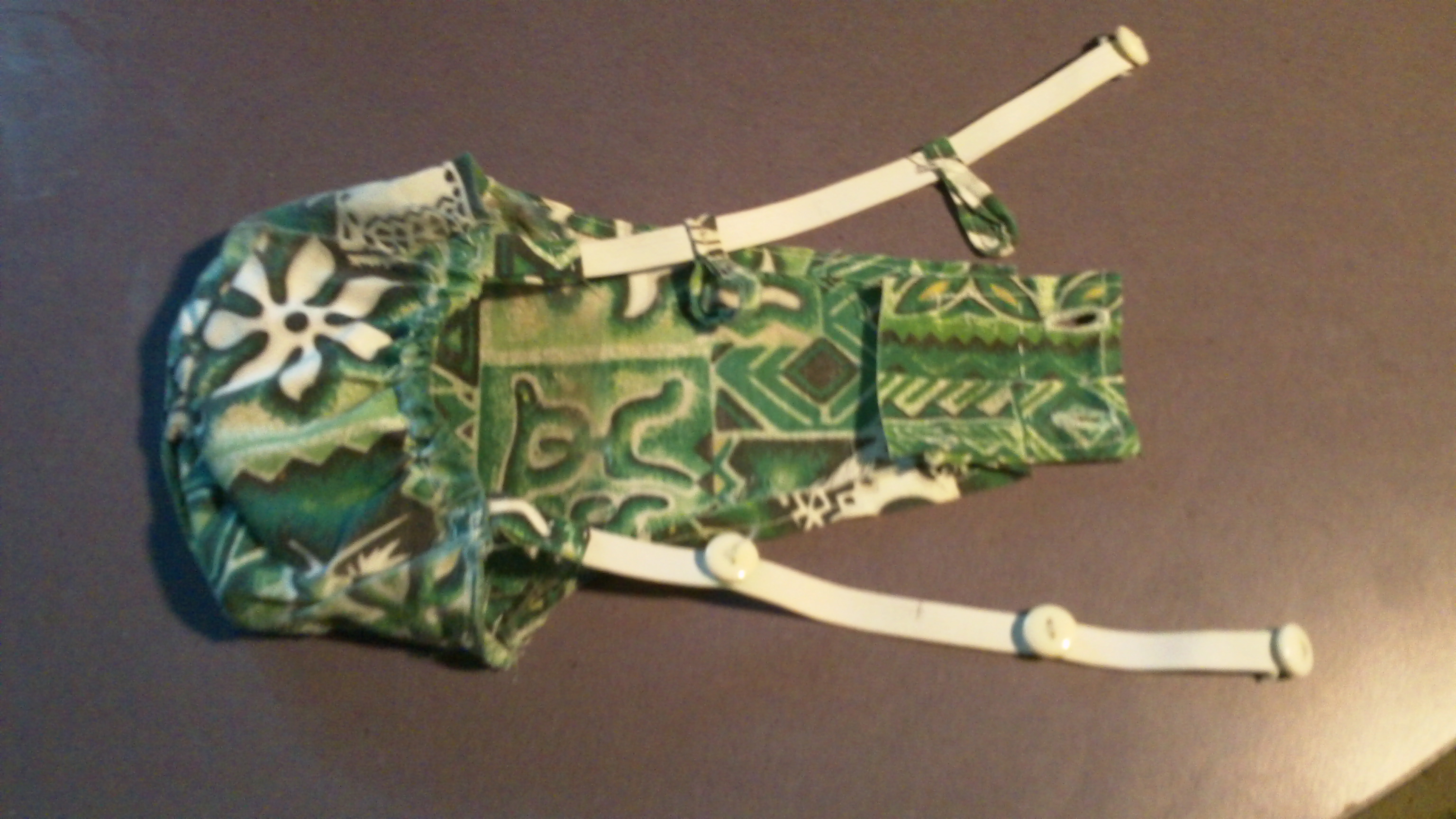 Version 2, deeper pouch and the multiple buttons keeps it from sliding around.