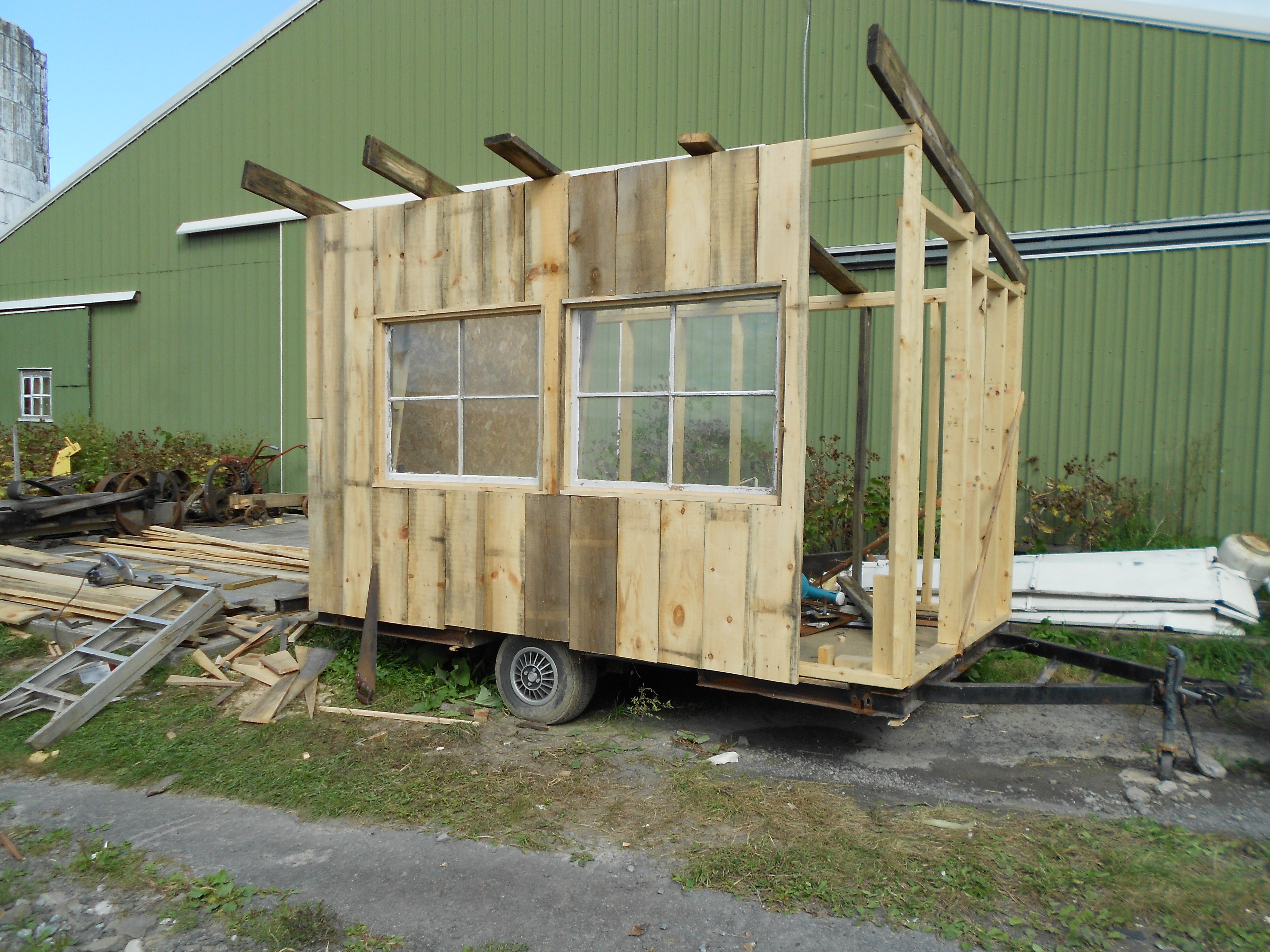 Vertical siding with windows installed. Windows designed to tip inward at the top