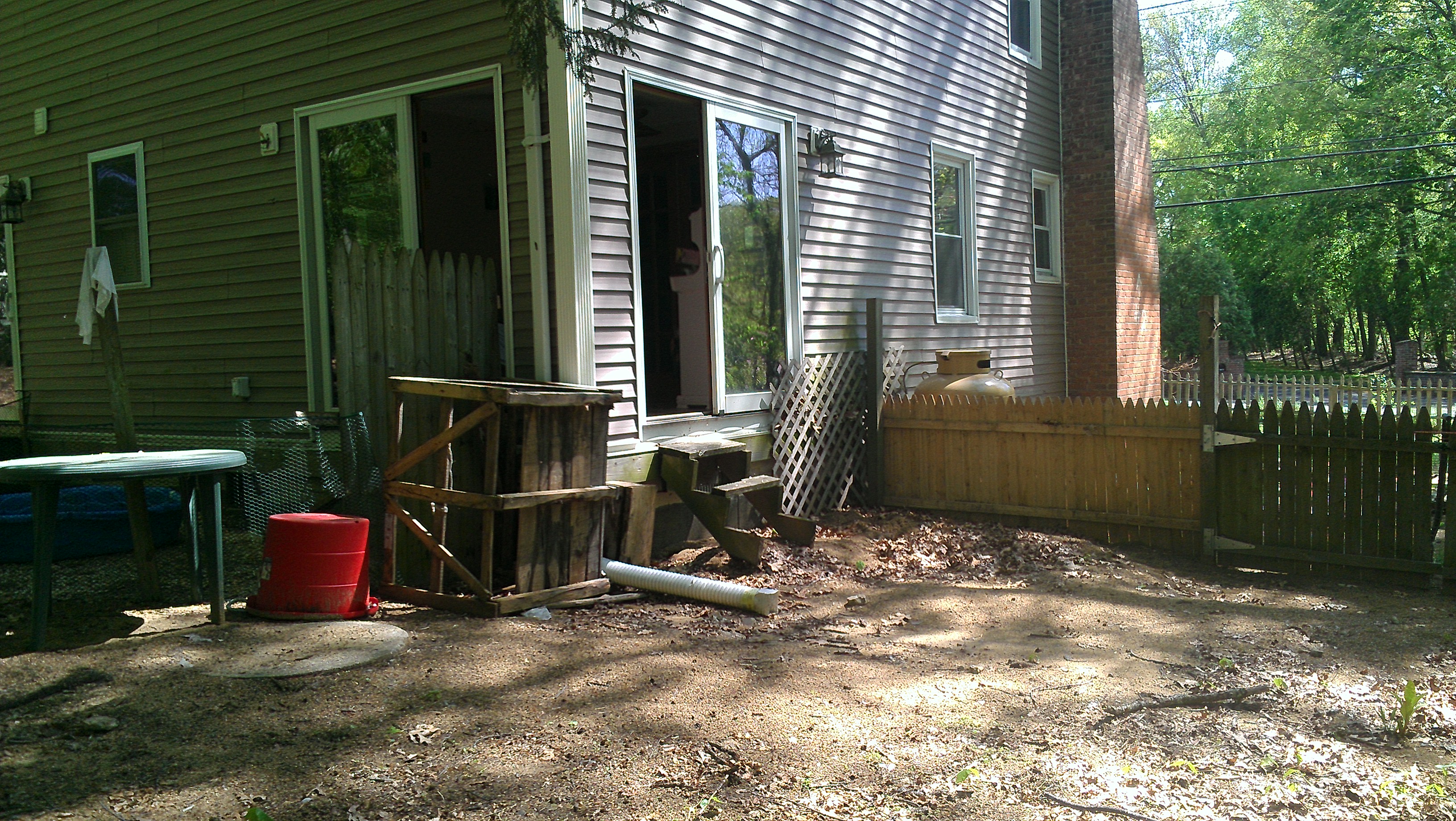 View from yard looking towards sunroom double sliders; can be atleast 28x40 if using whole side of yard along picket fence to back chain link gate