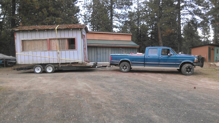 We bought the building for $50 from the neighbors, loaded it up and brought it home.  Here it is in the driveway.  Now for the fun of unloading it!