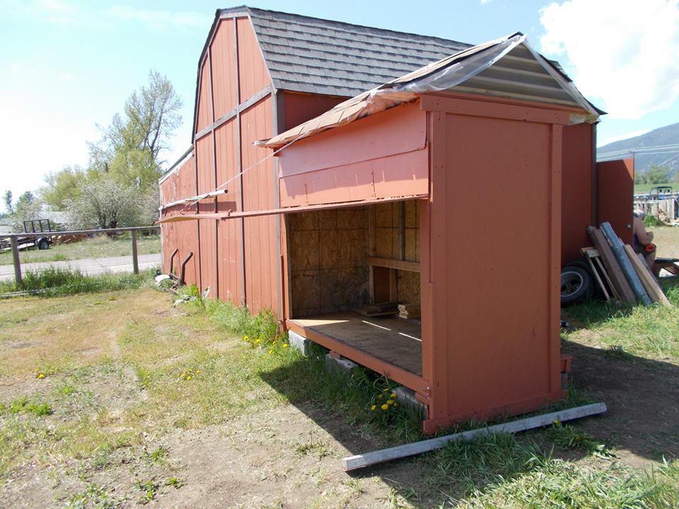 We decided to make the east wall of the coop hinged so we can open it for easy cleaning.  We put a chain with an "s" hook that hangs from the roof and a latch screwed into the bottom of the wall.  I used some leftover vinyl from our kitchen to put down on the floor of the coop - an exacto knife and a staple gun made that a pretty easy job.